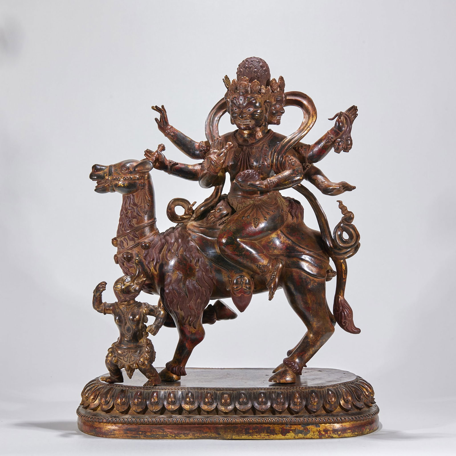 Ming Copper Lacquer-Gilt Palden Lhamo: A Ming copper lacquer-gilt Palden Lhamo, a Tibetan Buddhist guardian deity riding a mule and holding implements, fierce. Copper-bodied, lacquer-gilt, partly painted ?? a Ming esoteric image. H 66 cm,