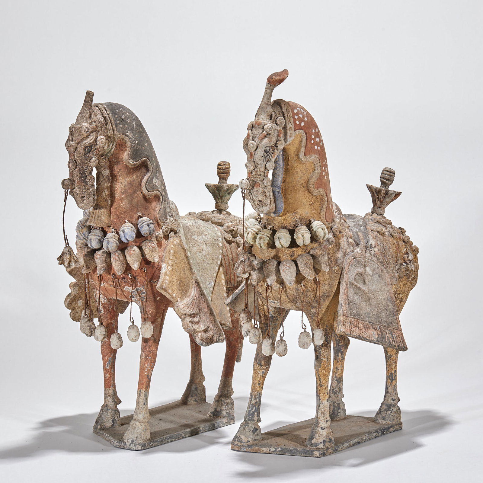 Pair of Northern-Wei Pottery Horses: A pair of Northern-Wei pottery horses, sturdy bodies, realistic, in neighing or walking poses. Grey-white bodies with partial paint, preserved as a pair ?? Northern-Dynasties pottery. H 40.5 cm, L 29