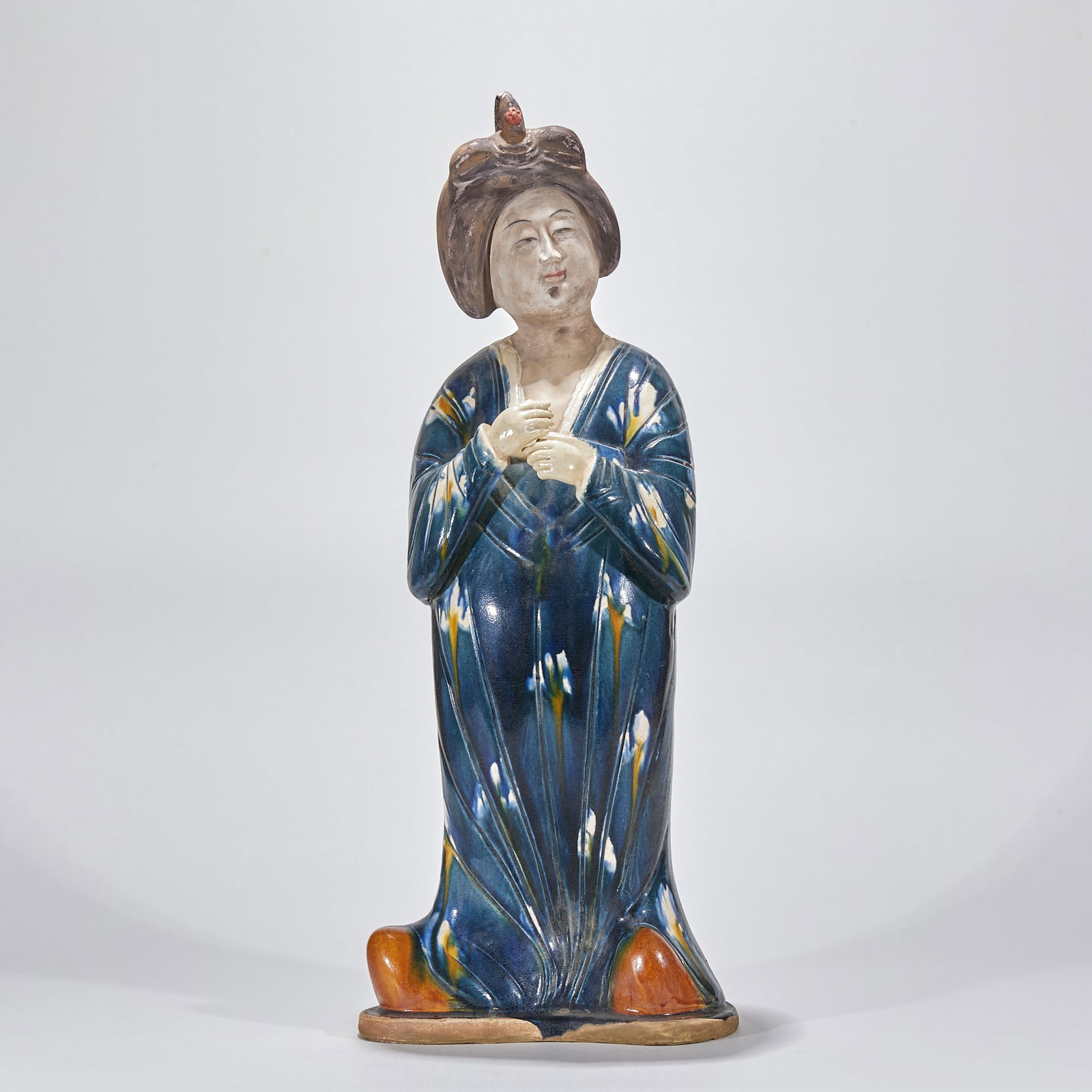 Tang Sancai Female Figurine: A Tang sancai female figurine of a lady, plump face, splendid garments, in three-colour glaze. Dignified form and brilliant glaze ?? a Tang sancai figurine. H 65 cm, L 26 cm, W 17 cm.