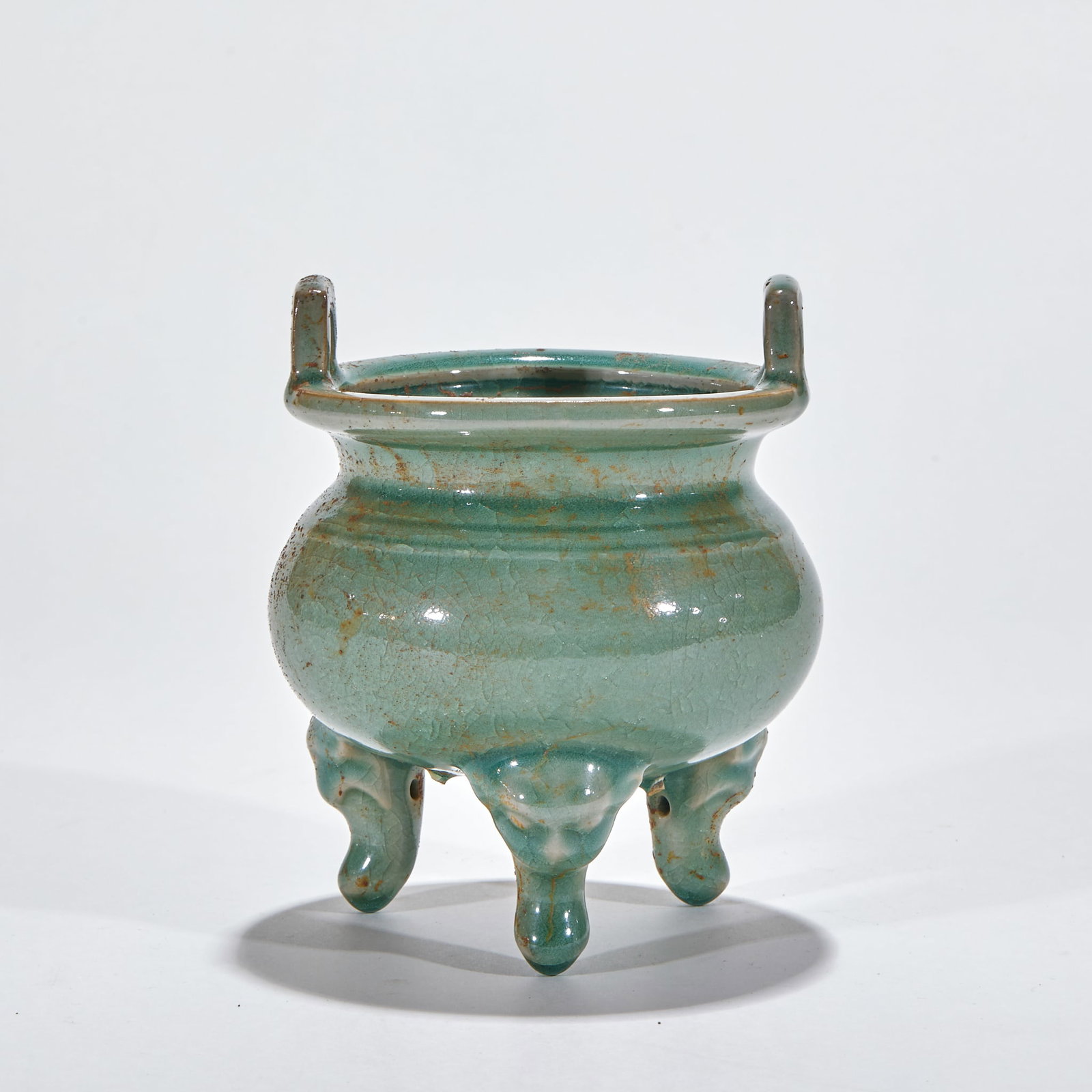 Longquan Kiln Tripod Censer: A Longquan tripod censer, round on three feet, glazed celadon, green and lustrous. Archaic form ?? an incense and display vessel of refined taste. H 13.5 cm, Diameter 11 cm.
