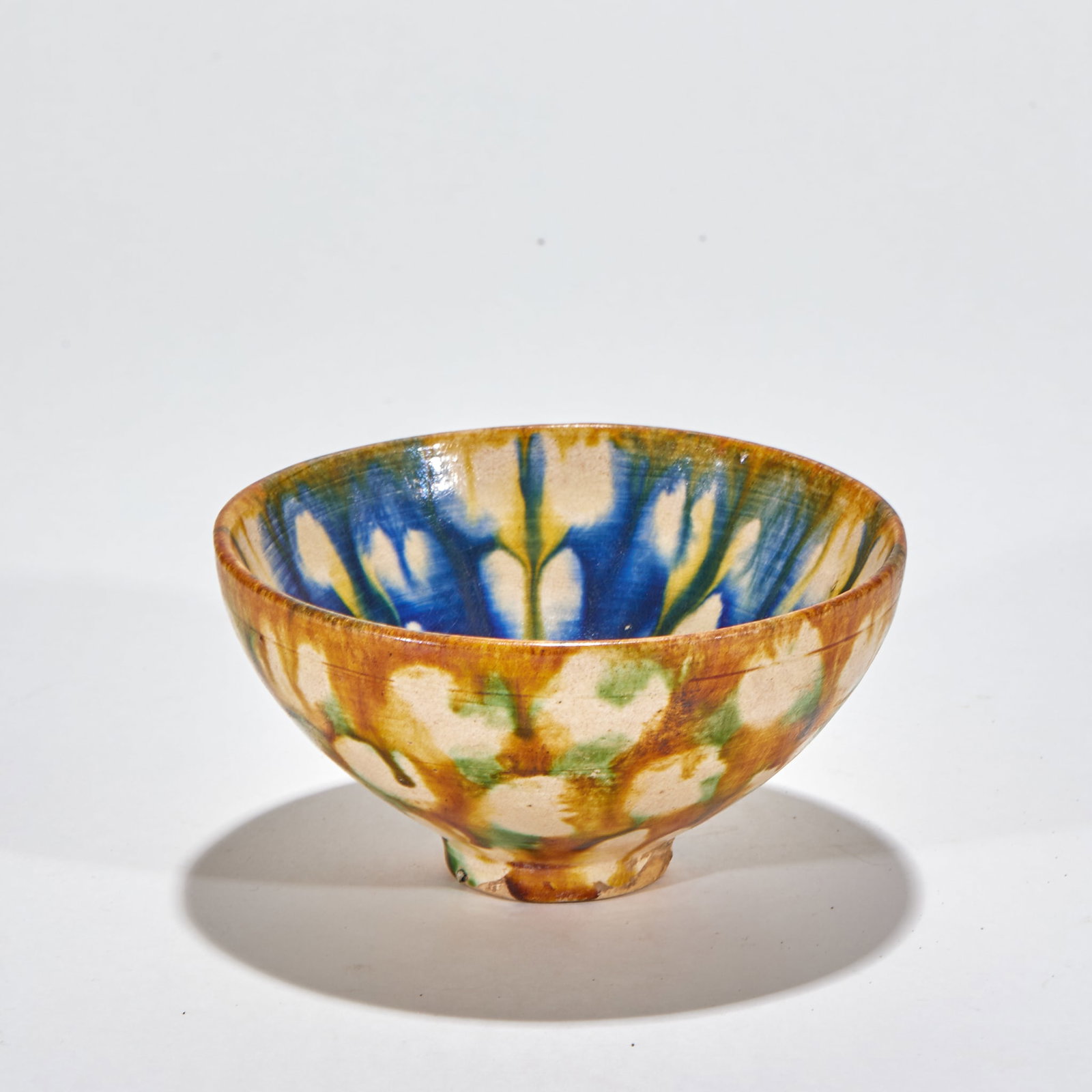 Sancai Bowl: A sancai bowl with green, yellow and white glazes interchanging, dazzling. Regular form ?? a Tang sancai-style pottery bowl of display value. H 7 cm, Diameter 13 cm.