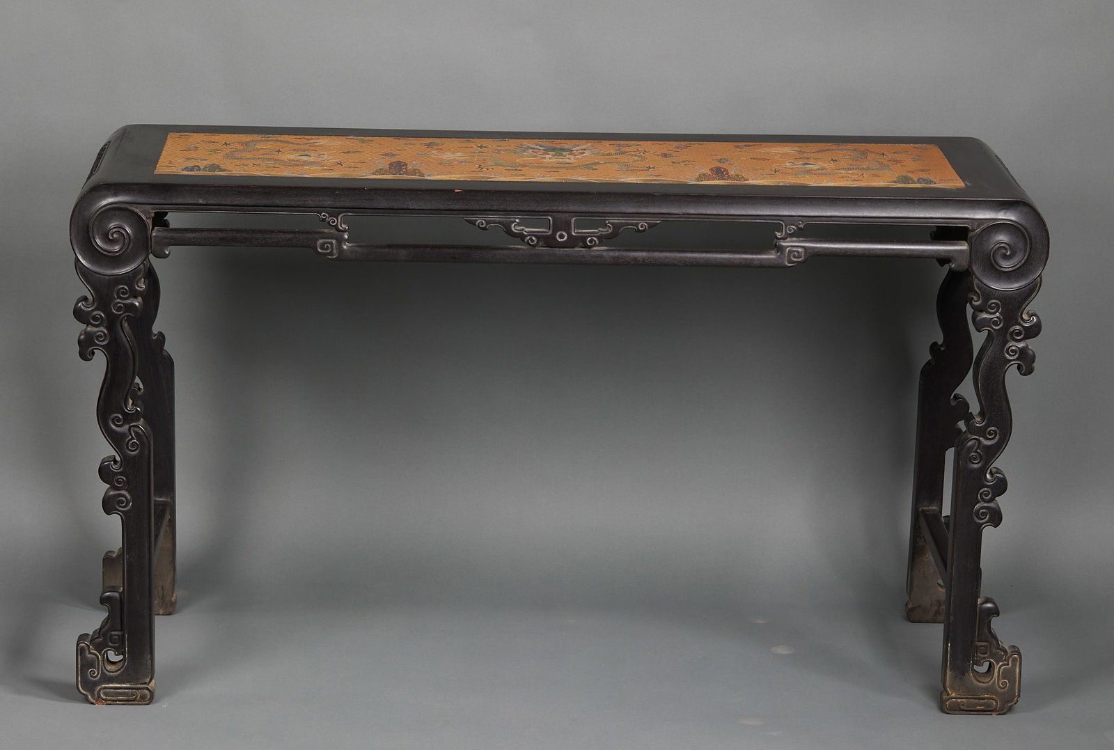 Zitan Clever-Carved Dragon Long Table: A zitan long table, flat top, the body cleverly carved with coiling dragons. Oily zitan with fine carving ?? Qing hardwood furniture. H 82 cm, L 145.5 cm, W 46 cm.