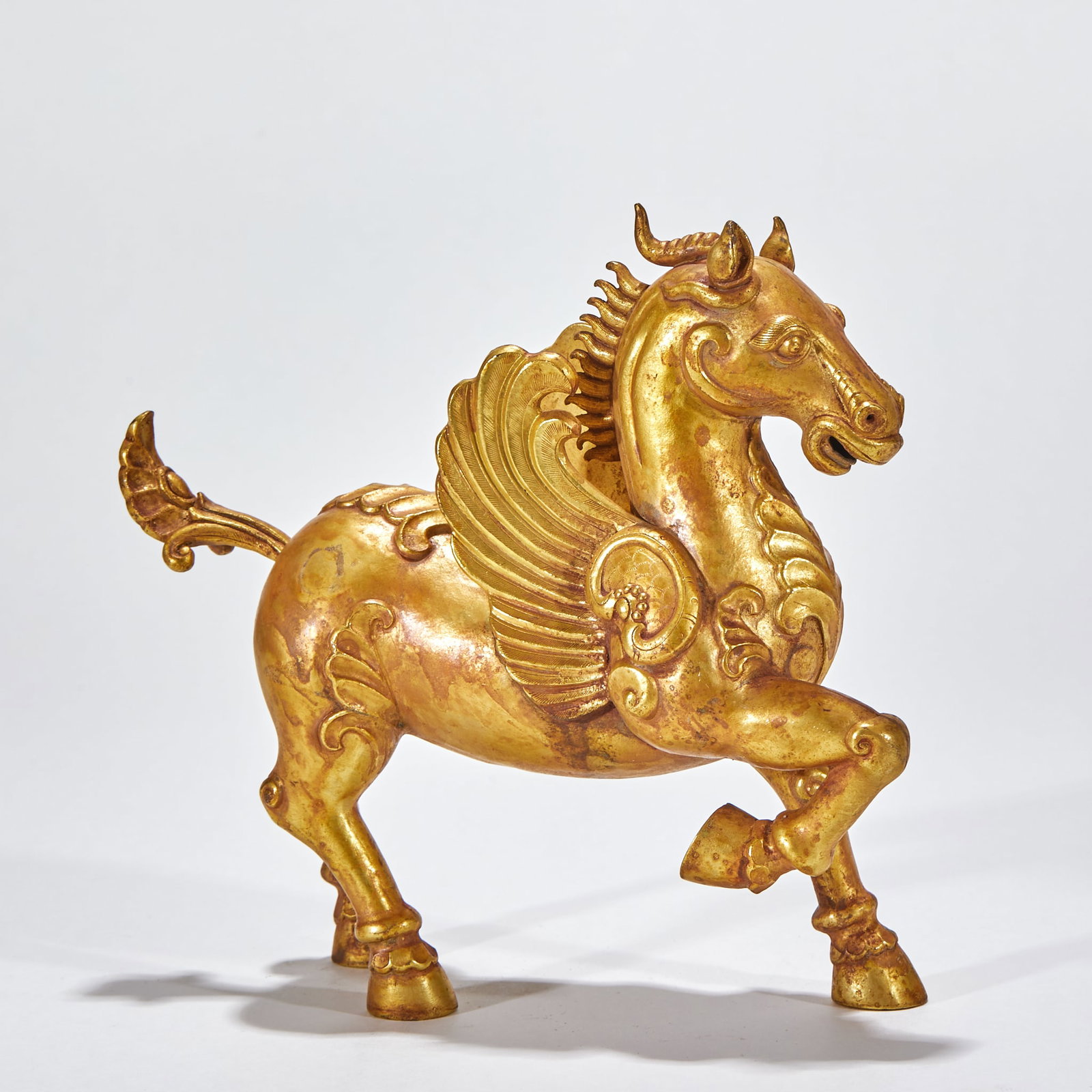 Gilt Copper Flying-Horse Ornament: A gilt-copper flying horse, body leaping, wings spread, vigorous. Gilded throughout, bright ?? a display ornament. H 17 cm, L 19 cm, W 6 cm, 552 g.