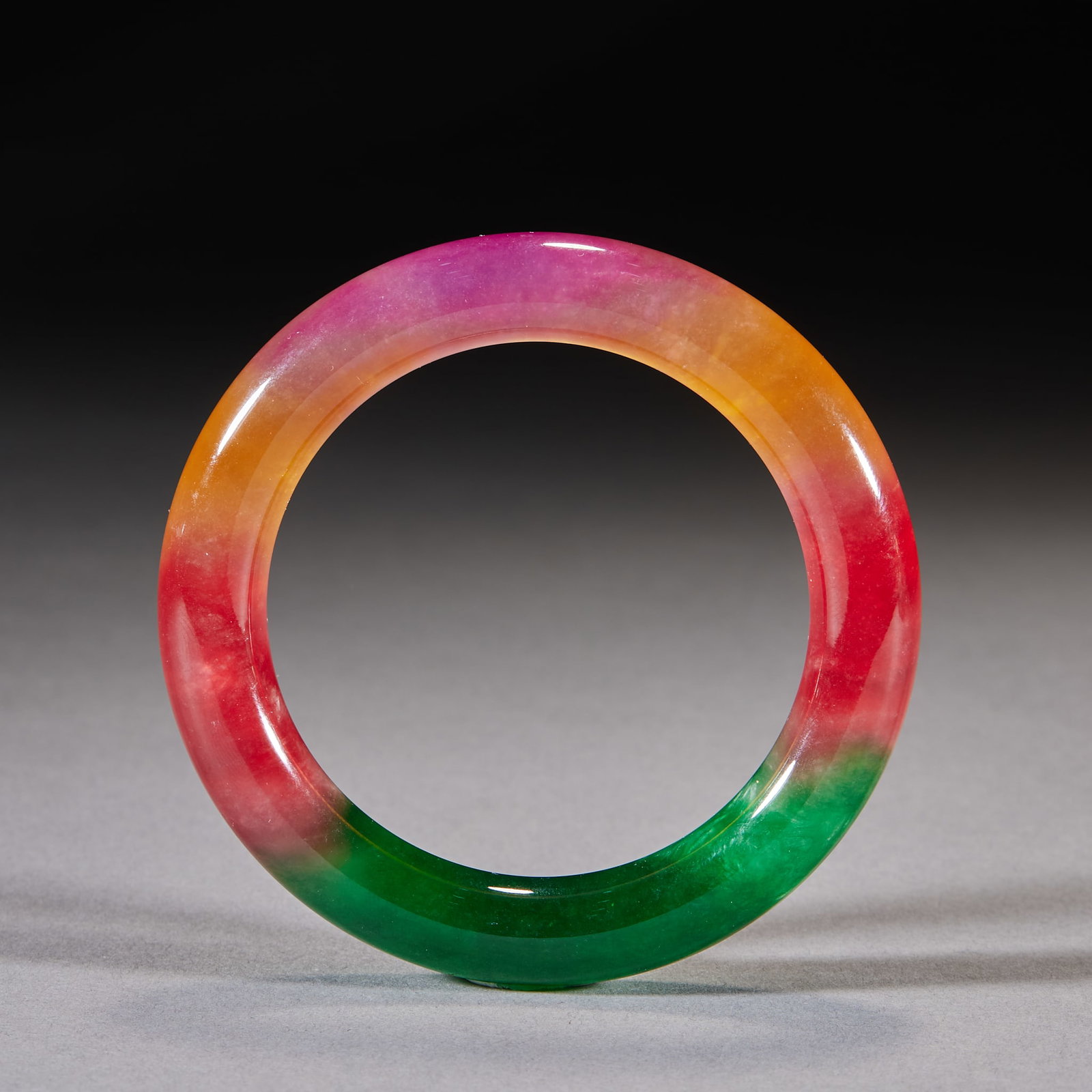 Jadeite Bangle: A jadeite bangle carved from one block, green and warm, fine texture, rounded rim. Plain to show jadeite's natural beauty ?? a fine piece for wearing and collecting. Inner diameter 5 cm.