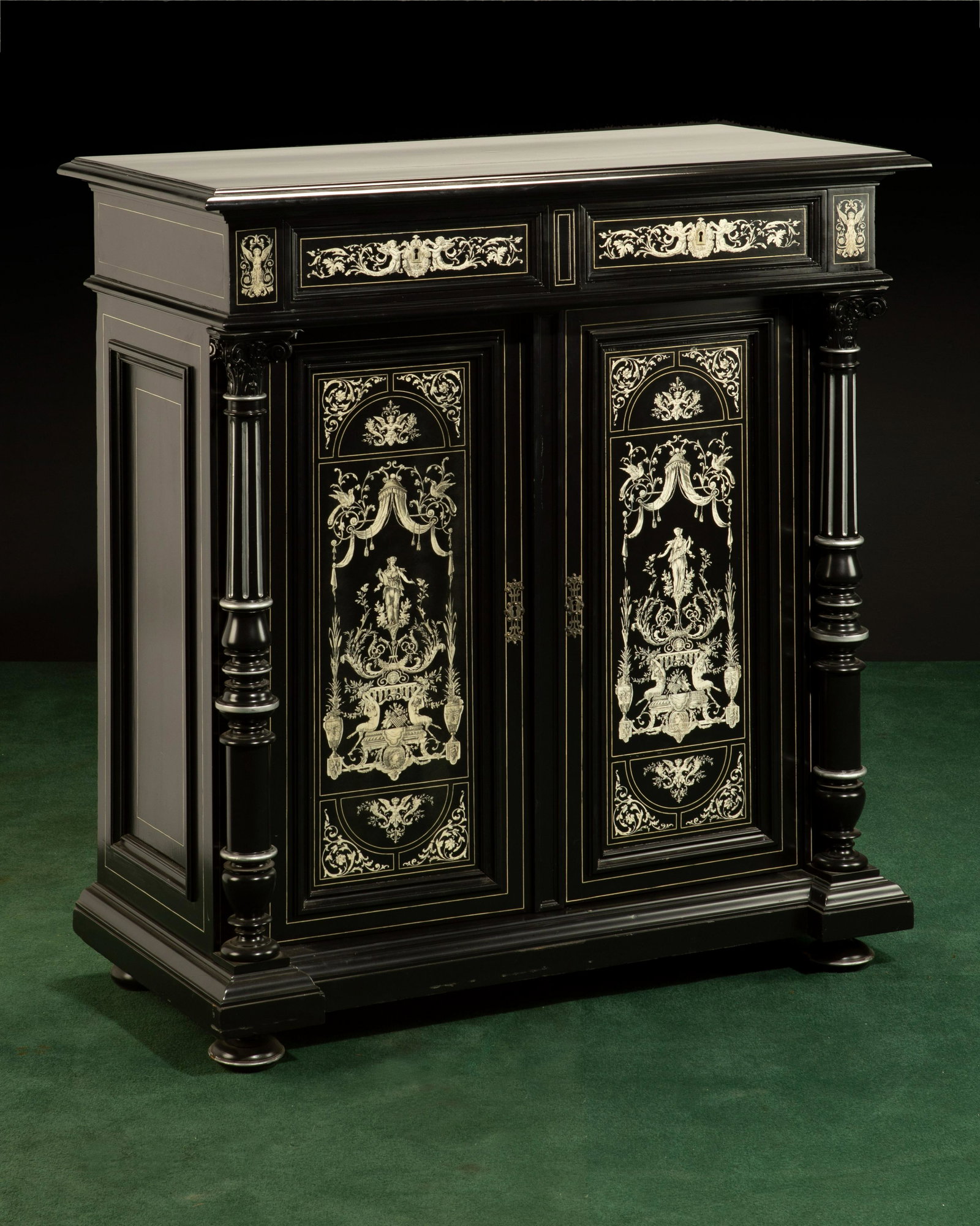 A Victorian Renaissance Revival cabinet: A Victorian Renaissance Revival cabinet Late 19th century The ebonized body with bone inlay of figural winged angels and motifs of nature, two upper drawers, and a double-door cabinet flanked by Corin