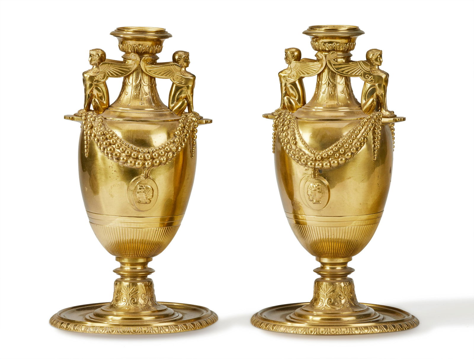 A pair of French-style Egyptian Revival brass urns (1 of 2)