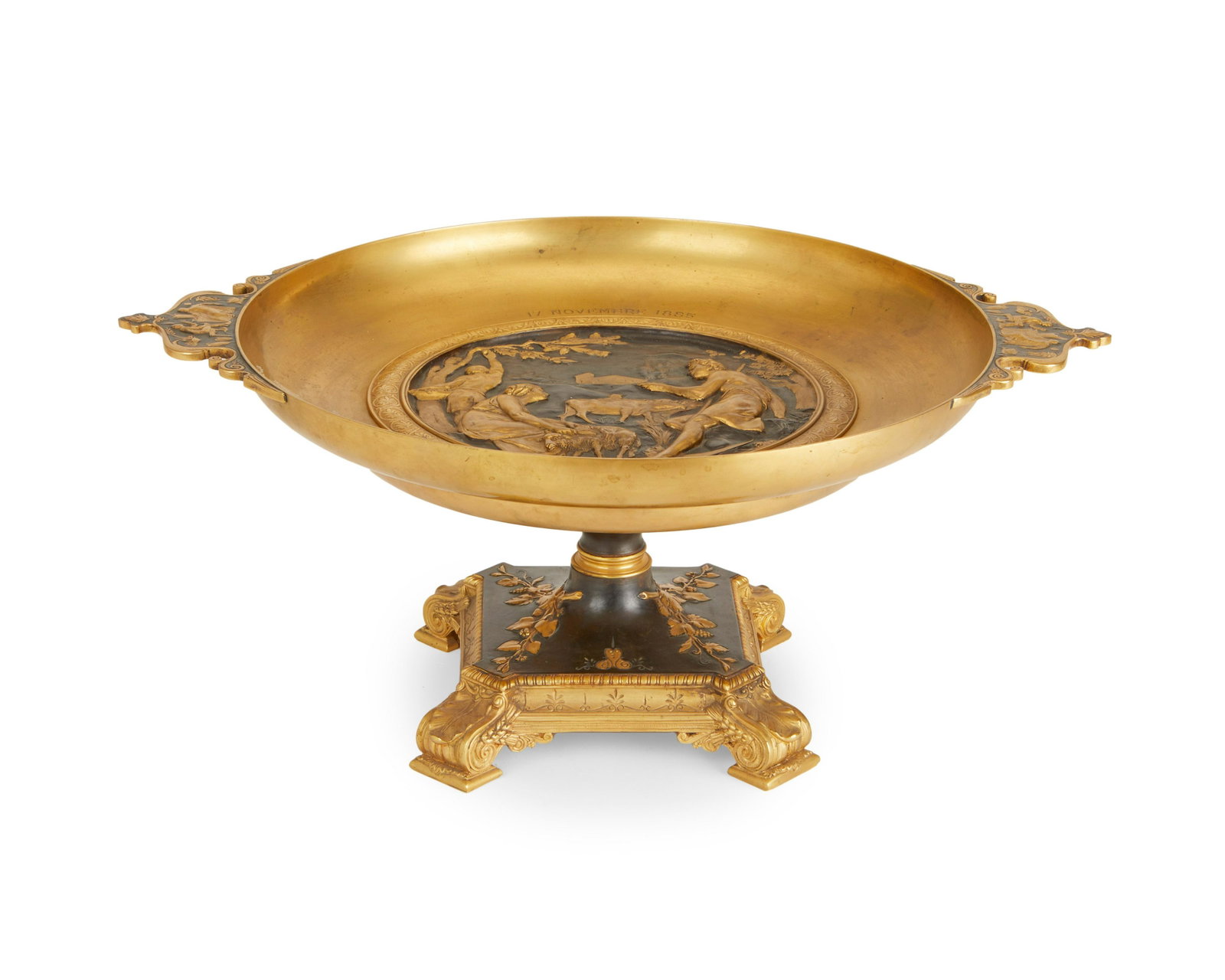 A French Empire-style bronze pedestal center bowl: A French Empire-style bronze pedestal center bowl Late 19th/early 20th century Signed: F. Picault; Presentation date to interior bowl: November 17 1883 - November 17 1935 The two-tone patinated bowl w