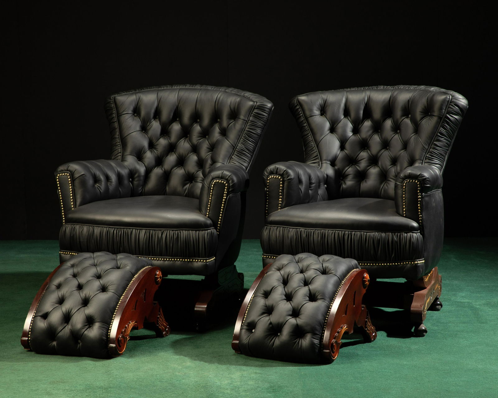 A pair of Victorian-style leather armchairs with footstools (1 of 3)
