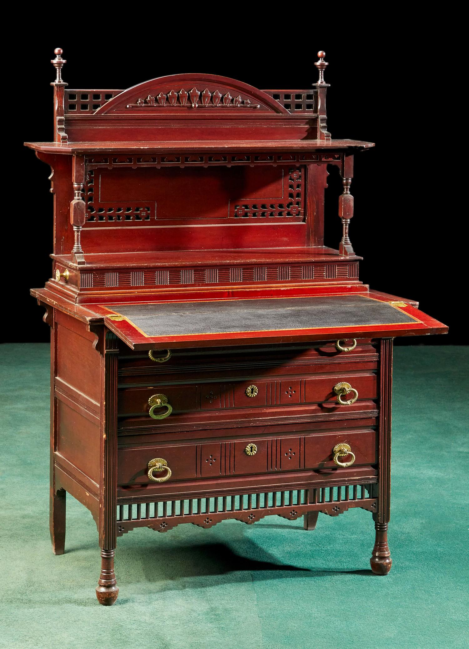 An American Eastlake ladies writing desk: An American Eastlake ladies writing desk Late 19th century Carved mahogany with reticulated panels, drop-down writing surface with gold-tooled leather, and original drop-ring brass hardware 50" H