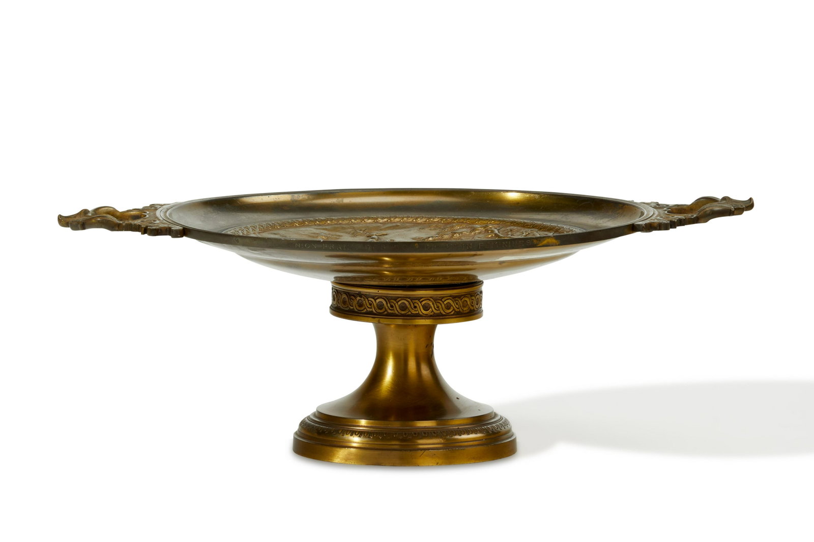 A bronze footed centerpiece: A bronze footed centerpiece Late 19th century The handled, round tray with central Roman figural scene on a pedestal base 7.5" H x 21" W x 15" D