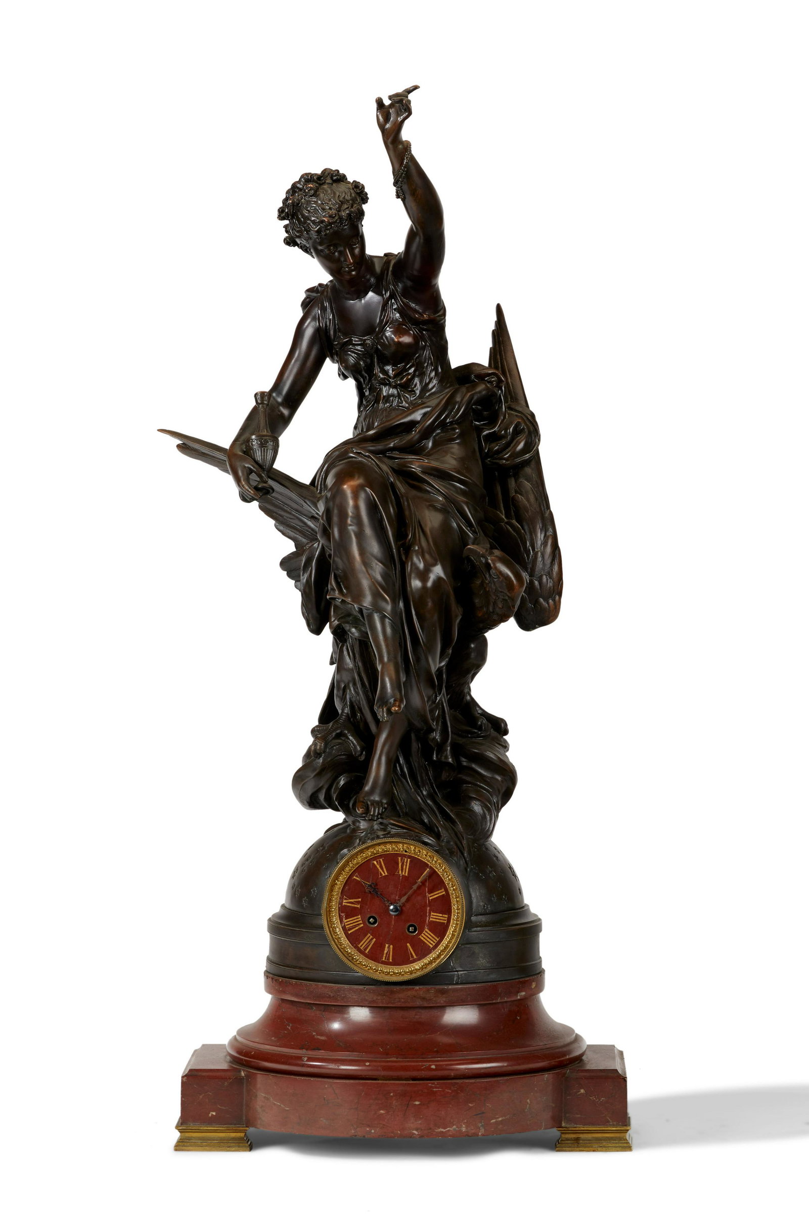 A French bronze and rouge marble figural clock: A French bronze and rouge marble figural clock Late 19th century With the Greek goddess Hebe sitting on the Eagle of Jupiter mounted to a rouge marble circular stepped base 39" H x 17" W x 1