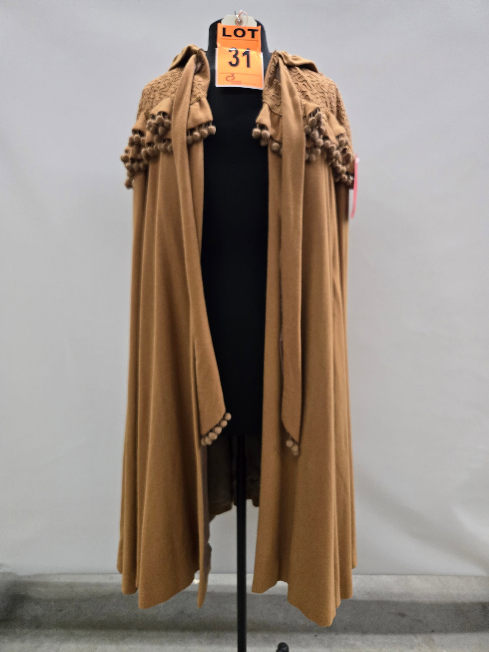 Cape, n/a, mustard wool with hood, soutache shoulder trim and ball fringe, real vintage.: Cape, n/a, mustard wool with hood, soutache shoulder trim and ball fringe, real vintage. IMPORTANT NOTE TO BIDDERS: We are not an auction gallery but a liquidator retained by CRC as they wind-down ope