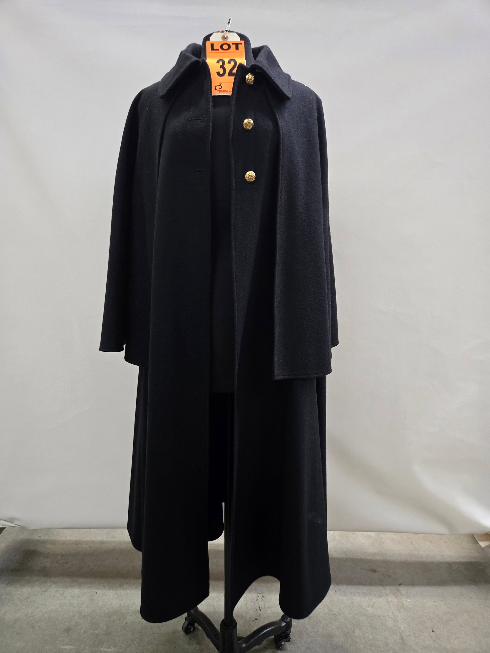 Inverness coat, n/a, black wool, gold buttons (men’s).: Inverness coat, n/a, black wool, gold buttons (men’s). IMPORTANT NOTE TO BIDDERS: We are not an auction gallery but a liquidator retained by CRC as they wind-down operations. As such, we cannot 