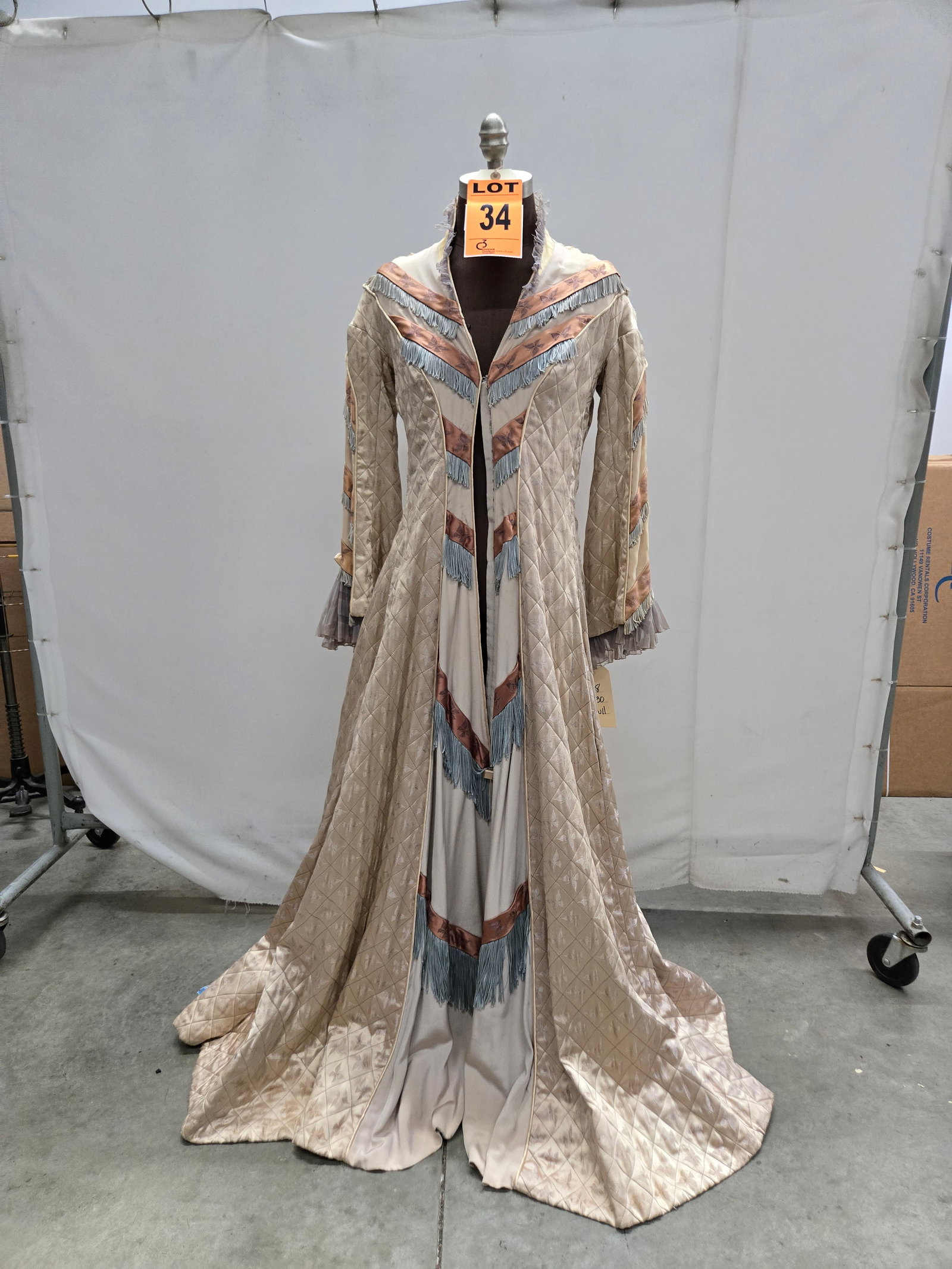 Tea wrapper, circa 1880s, cream quilted, butterfly motif, studio made.: Tea wrapper, circa 1880s, cream quilted, butterfly motif, studio made. IMPORTANT NOTE TO BIDDERS: We are not an auction gallery but a liquidator retained by CRC as they wind-down operations. As such, 