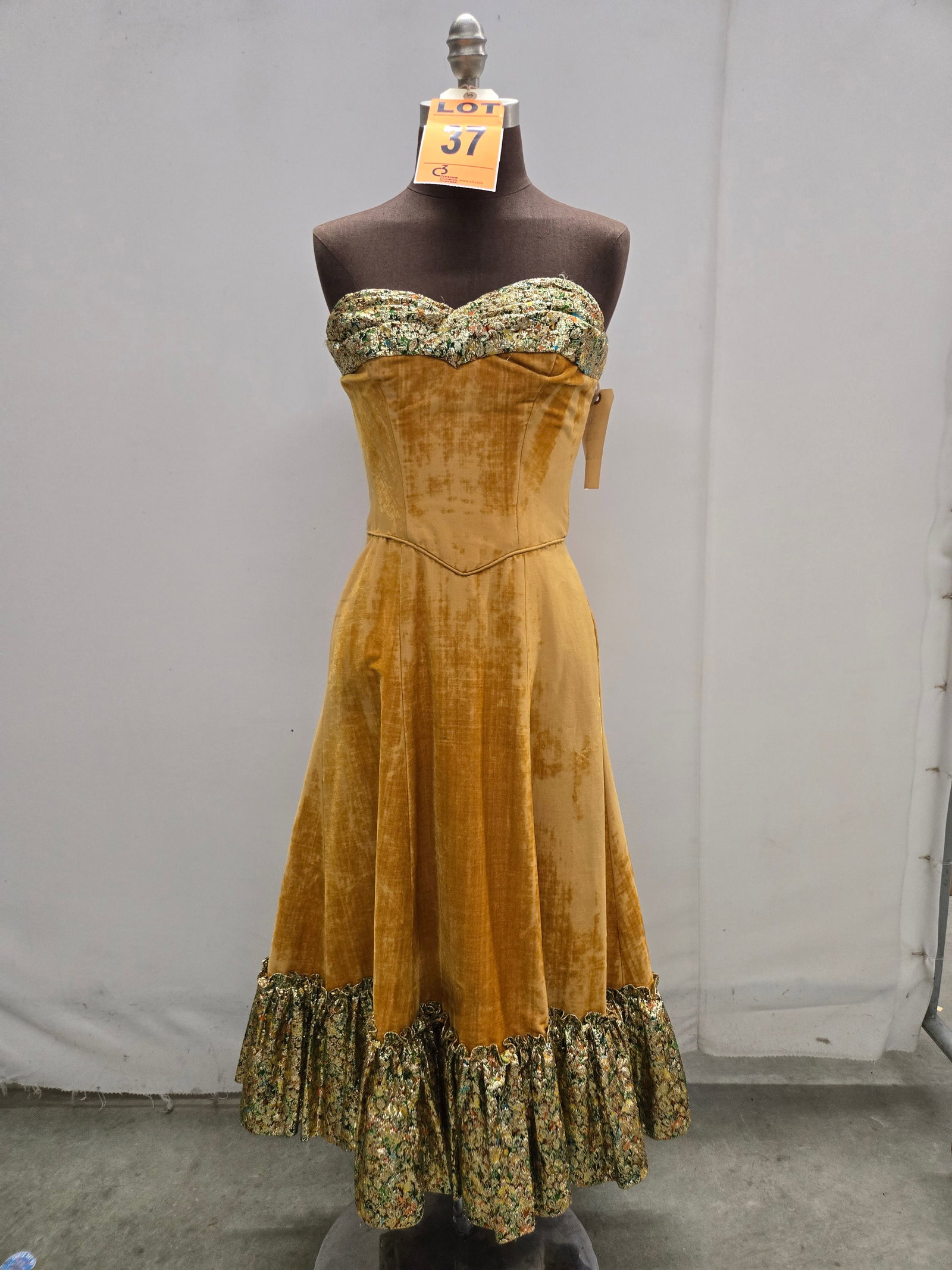Saloon girl costume, n/a, gold velvet, distressed finish, studio made.: Saloon girl costume, n/a, gold velvet, distressed finish, studio made. IMPORTANT NOTE TO BIDDERS: We are not an auction gallery but a liquidator retained by CRC as they wind-down operations. As such, 