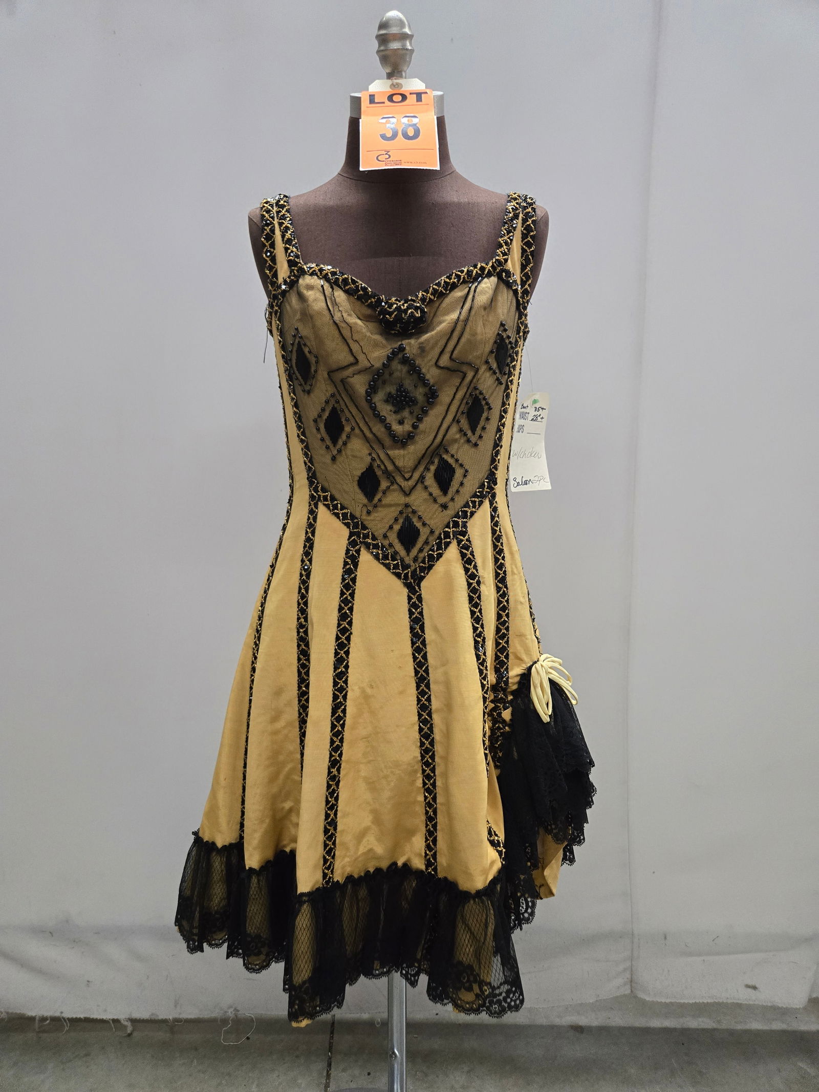 Saloon girl costume, n/a, yellow faille, two-piece with black/gold beaded trim, studio made.: Saloon girl costume, n/a, yellow faille, two-piece with black/gold beaded trim, studio made. IMPORTANT NOTE TO BIDDERS: We are not an auction gallery but a liquidator retained by CRC as they wind-down