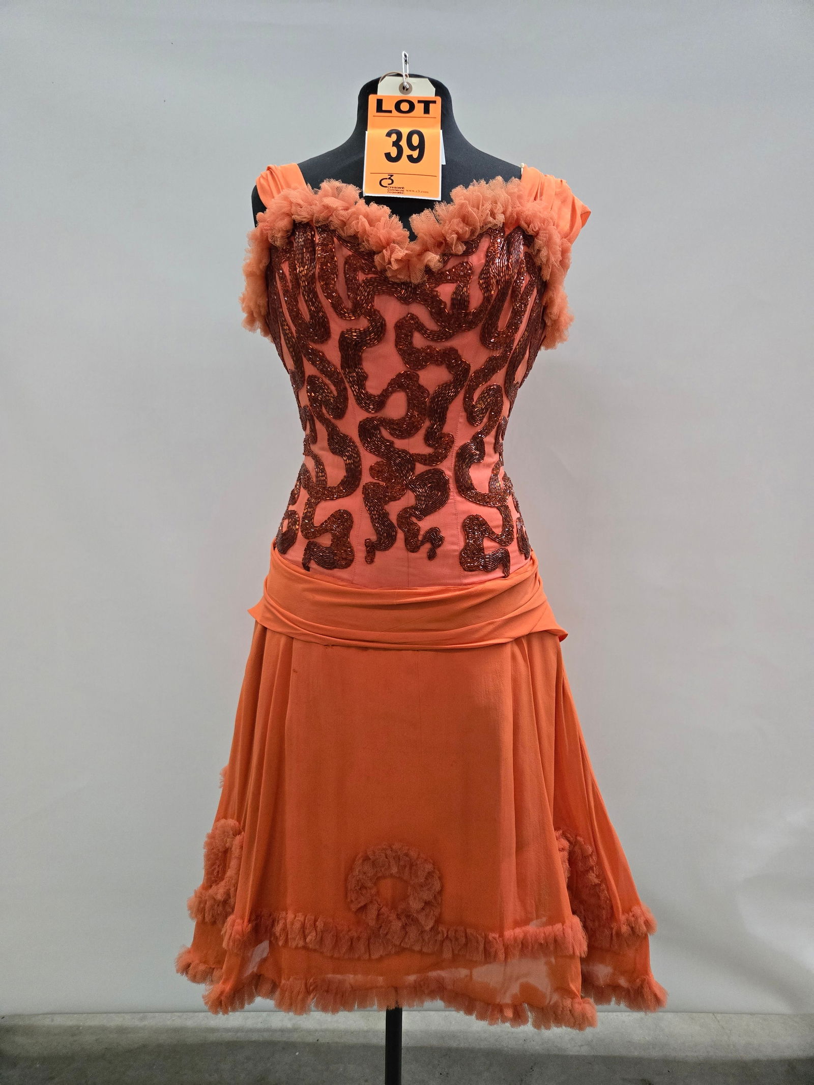 Saloon girl costume, n/a, orange crepe, ribbon-beaded bodice, studio made.: Saloon girl costume, n/a, orange crepe, ribbon-beaded bodice, studio made. IMPORTANT NOTE TO BIDDERS: We are not an auction gallery but a liquidator retained by CRC as they wind-down operations. As su