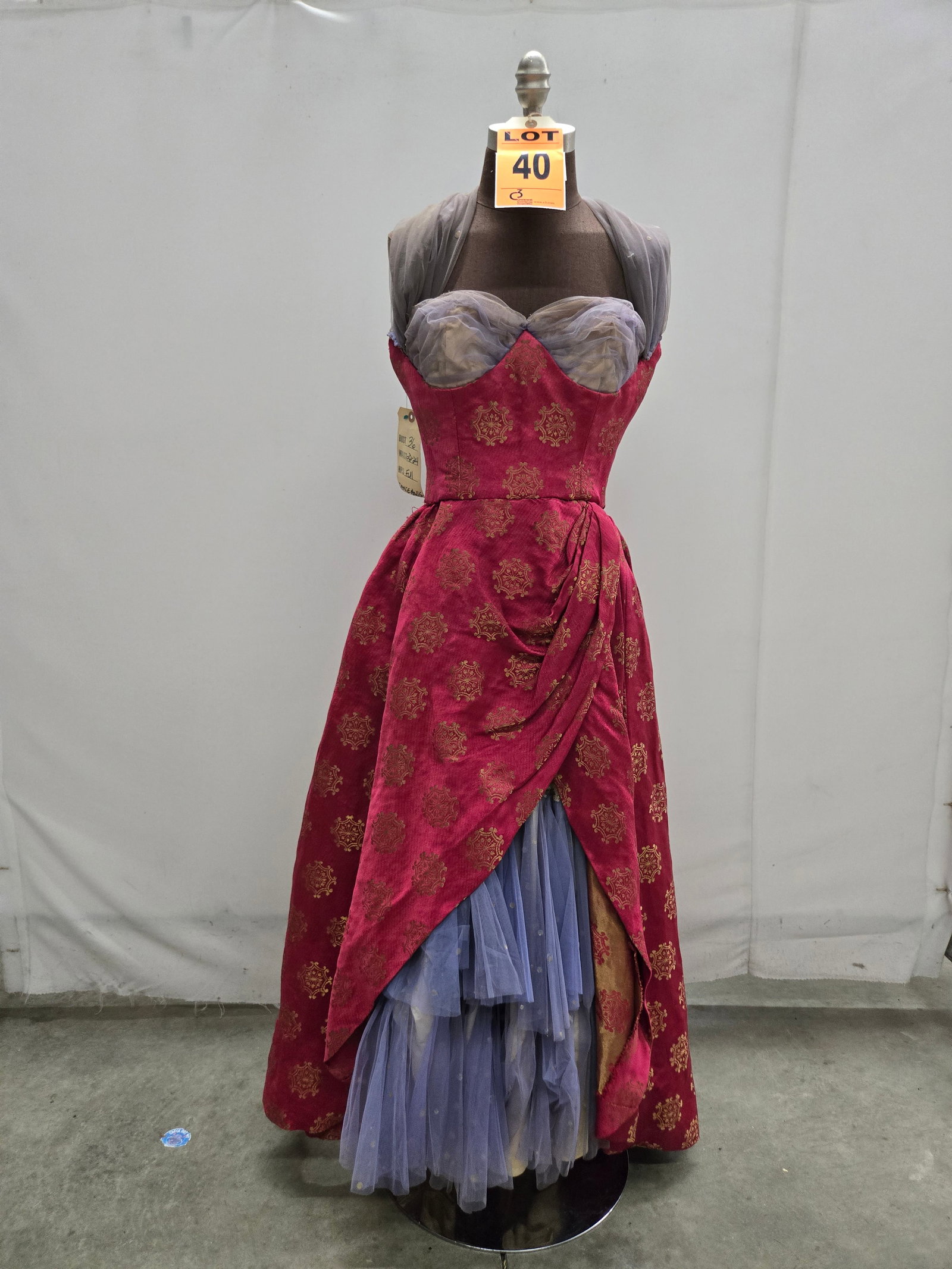 Saloon girl costume, n/a, red/gold brocade, grey tulle trim, studio made.: Saloon girl costume, n/a, red/gold brocade, grey tulle trim, studio made. IMPORTANT NOTE TO BIDDERS: We are not an auction gallery but a liquidator retained by CRC as they wind-down operations. As suc