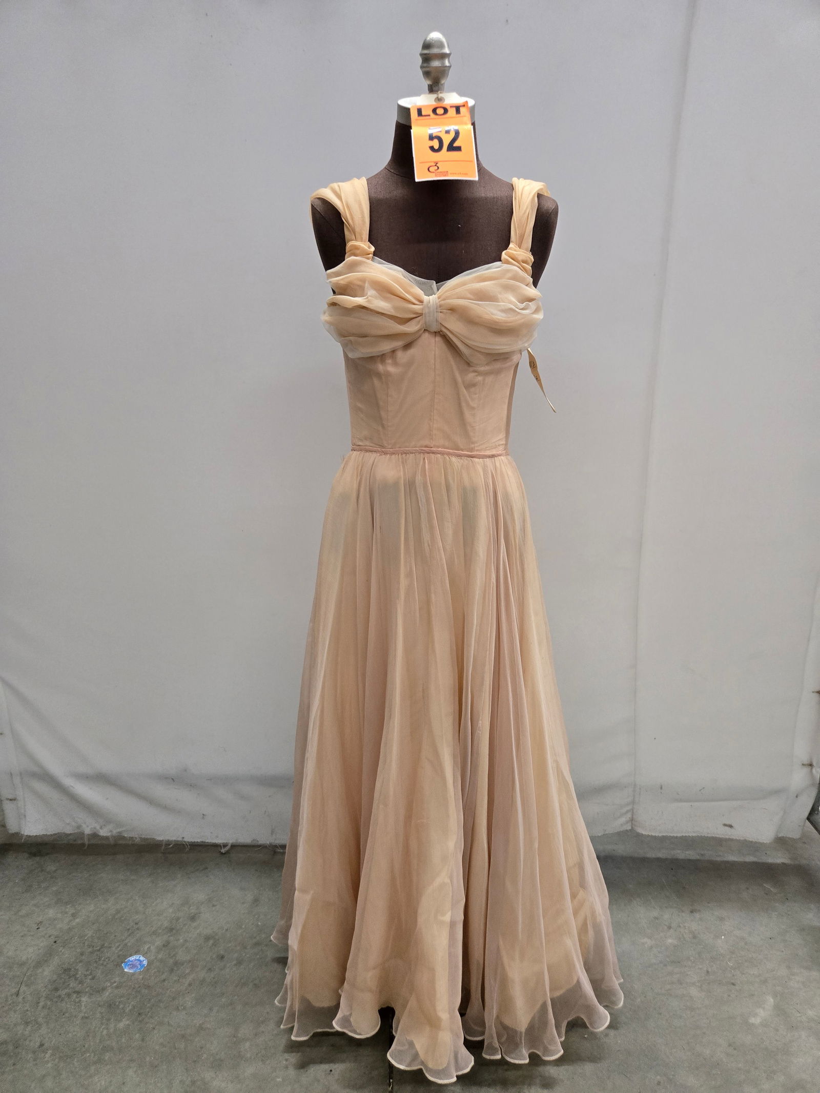 Evening gown, 1950s, peach silk over peach taffeta, gathered bust with ribbon straps, n/a.: Evening gown, 1950s, peach silk over peach taffeta, gathered bust with ribbon straps, n/a. IMPORTANT NOTE TO BIDDERS: We are not an auction gallery but a liquidator retained by CRC as they wind-down o