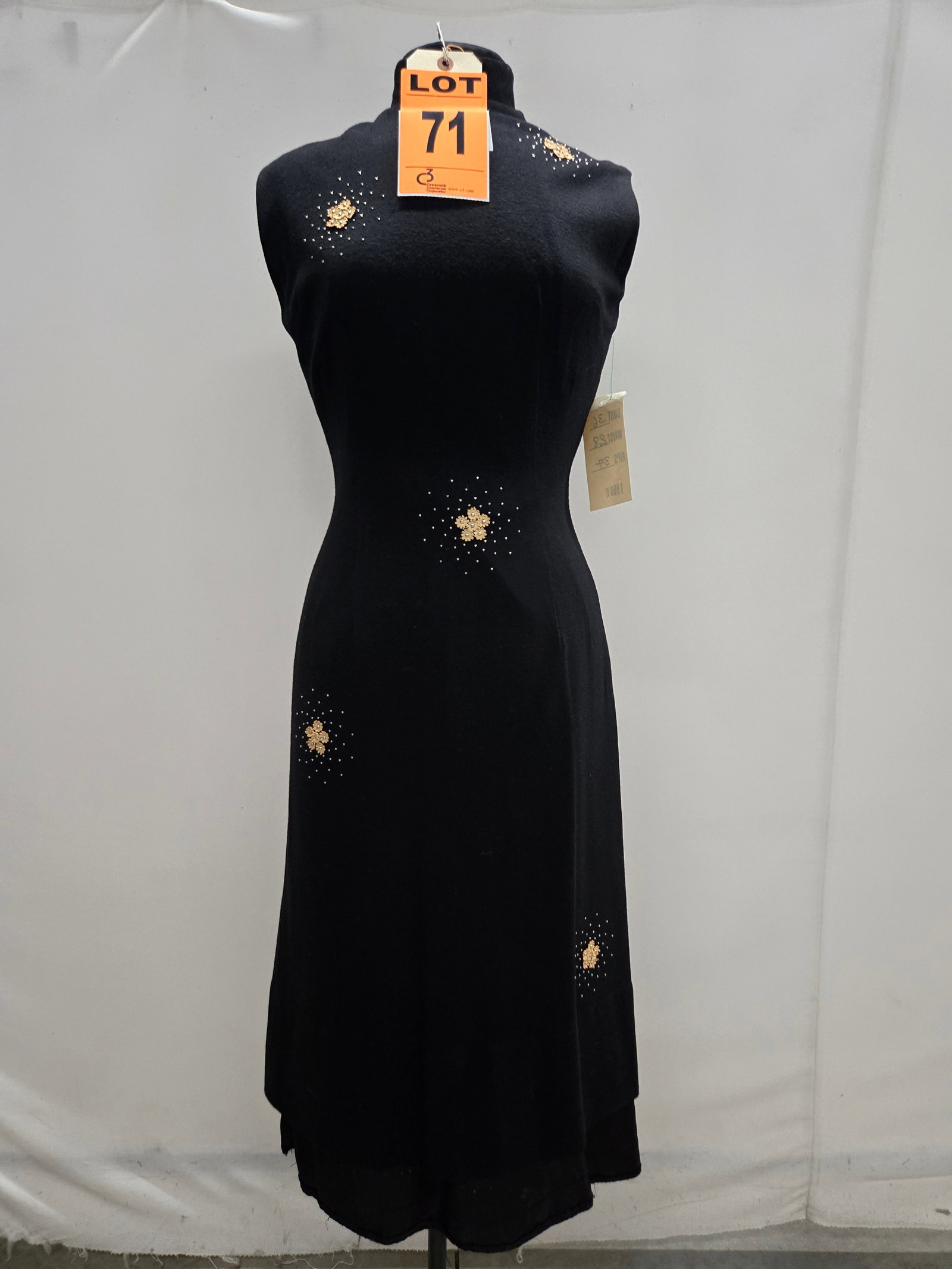 Cocktail dress, 1950s, black wool, silver studs with scattered cream flowers, mandarin collar.: Cocktail dress, 1950s, black wool, silver studs with scattered cream flowers, mandarin collar. IMPORTANT NOTE TO BIDDERS: We are not an auction gallery but a liquidator retained by CRC as they wind-do