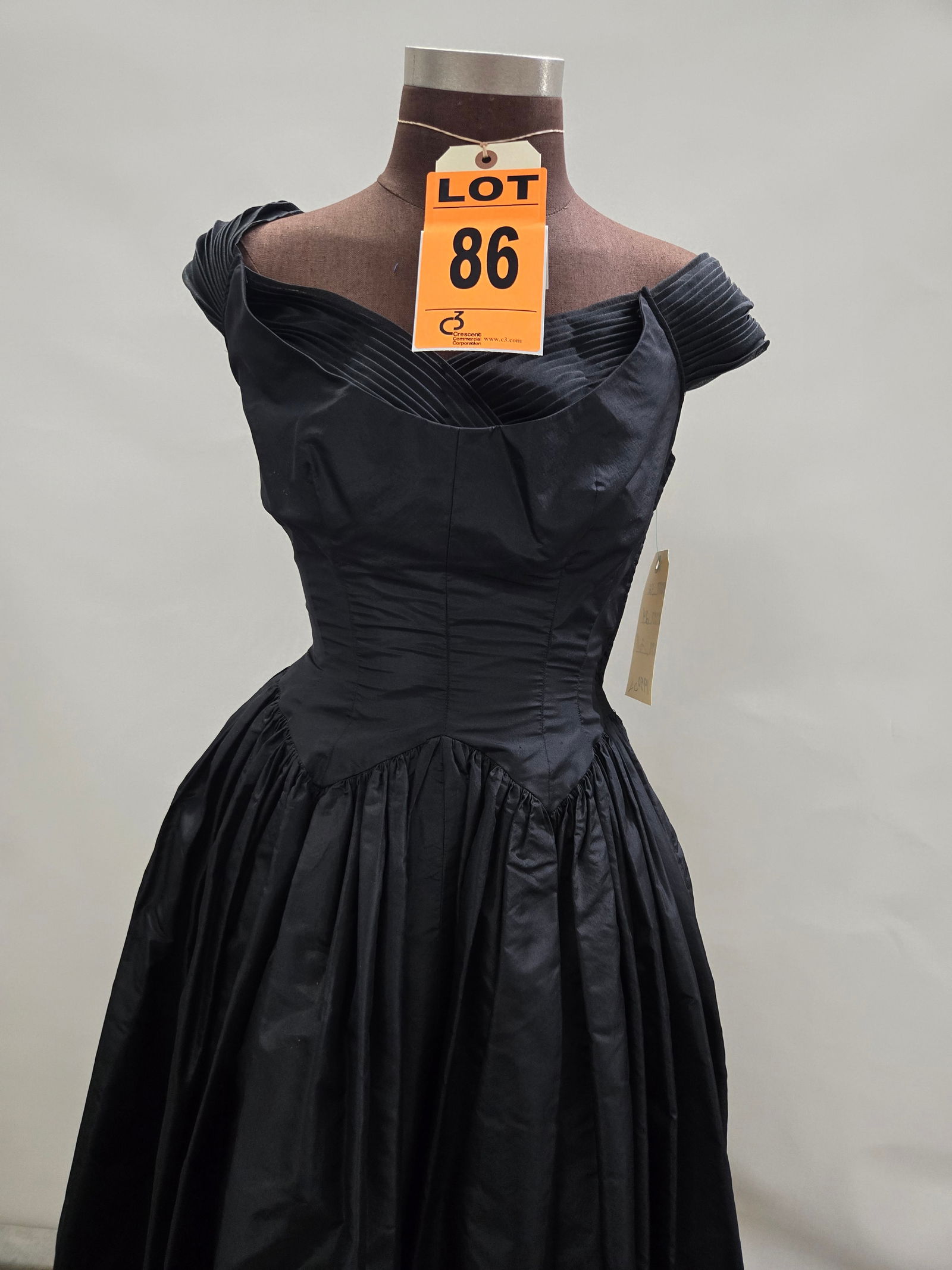 Cocktail dress, 1950s, black silk, drop waist with pleated neckline.: Cocktail dress, 1950s, black silk, drop waist with pleated neckline. IMPORTANT NOTE TO BIDDERS: We are not an auction gallery but a liquidator retained by CRC as they wind-down operations. As such, we
