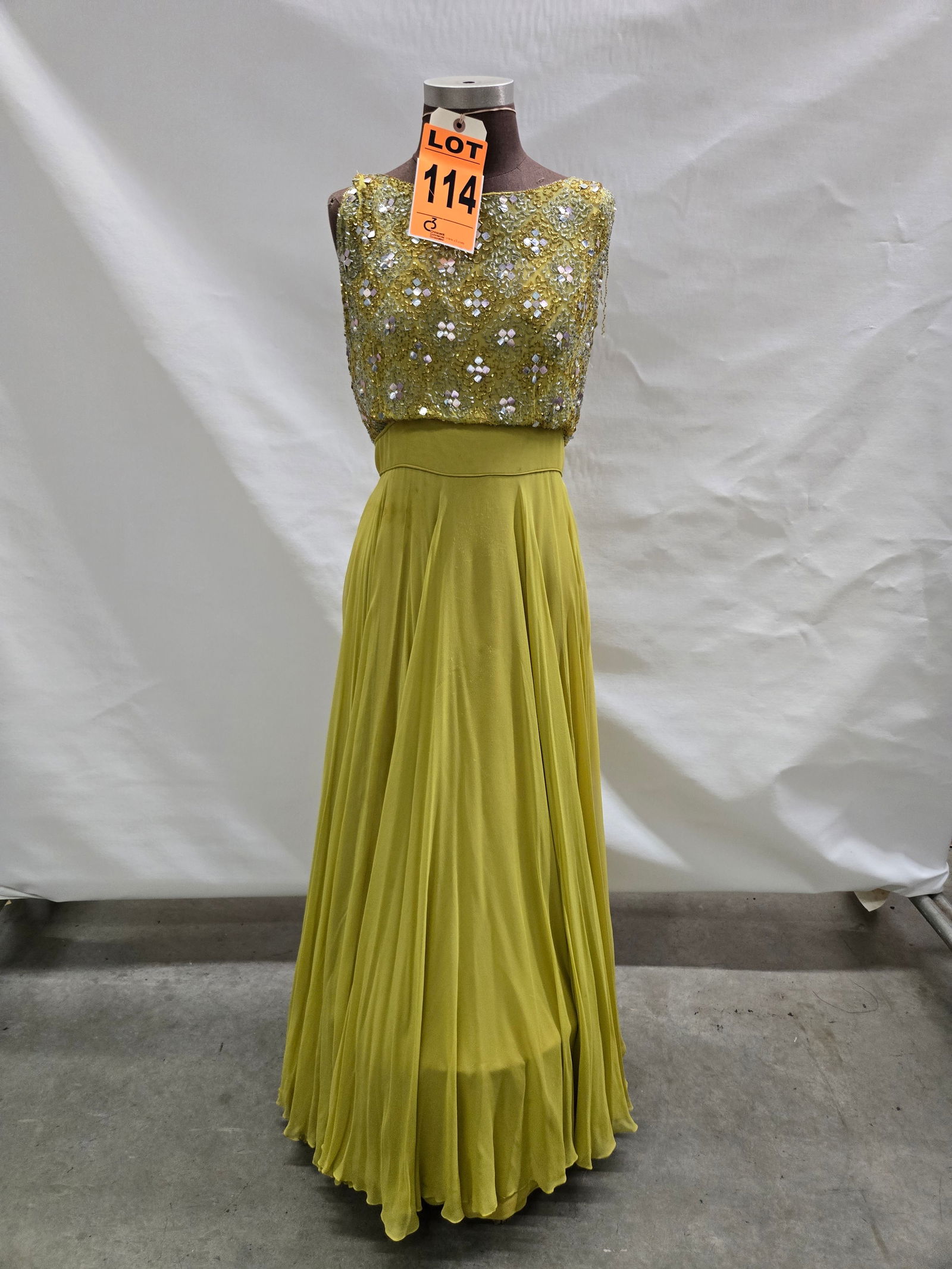 Evening gown, 1960s, chartreuse silk chiffon, gold/silver vermicelli with silver sequins and pearls: Evening gown, 1960s, chartreuse silk chiffon, gold/silver vermicelli with silver sequins and pearls on bodice. IMPORTANT NOTE TO BIDDERS: We are not an auction gallery but a liquidator retained by CRC