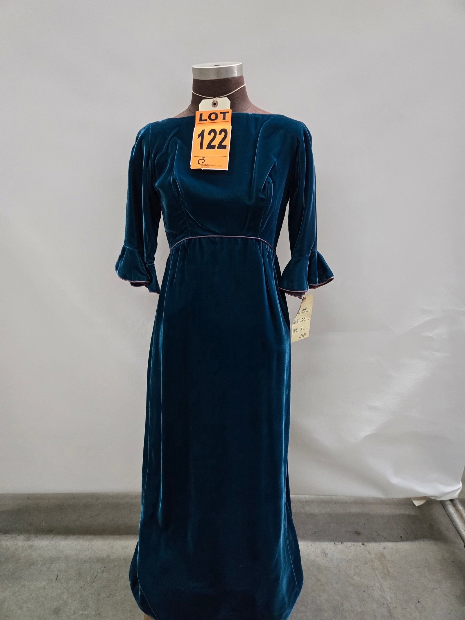 Evening gown, 1960s, teal velvet, empire waist, three-quarter sleeve.: Evening gown, 1960s, teal velvet, empire waist, three-quarter sleeve. IMPORTANT NOTE TO BIDDERS: We are not an auction gallery but a liquidator retained by CRC as they wind-down operations. As such, w