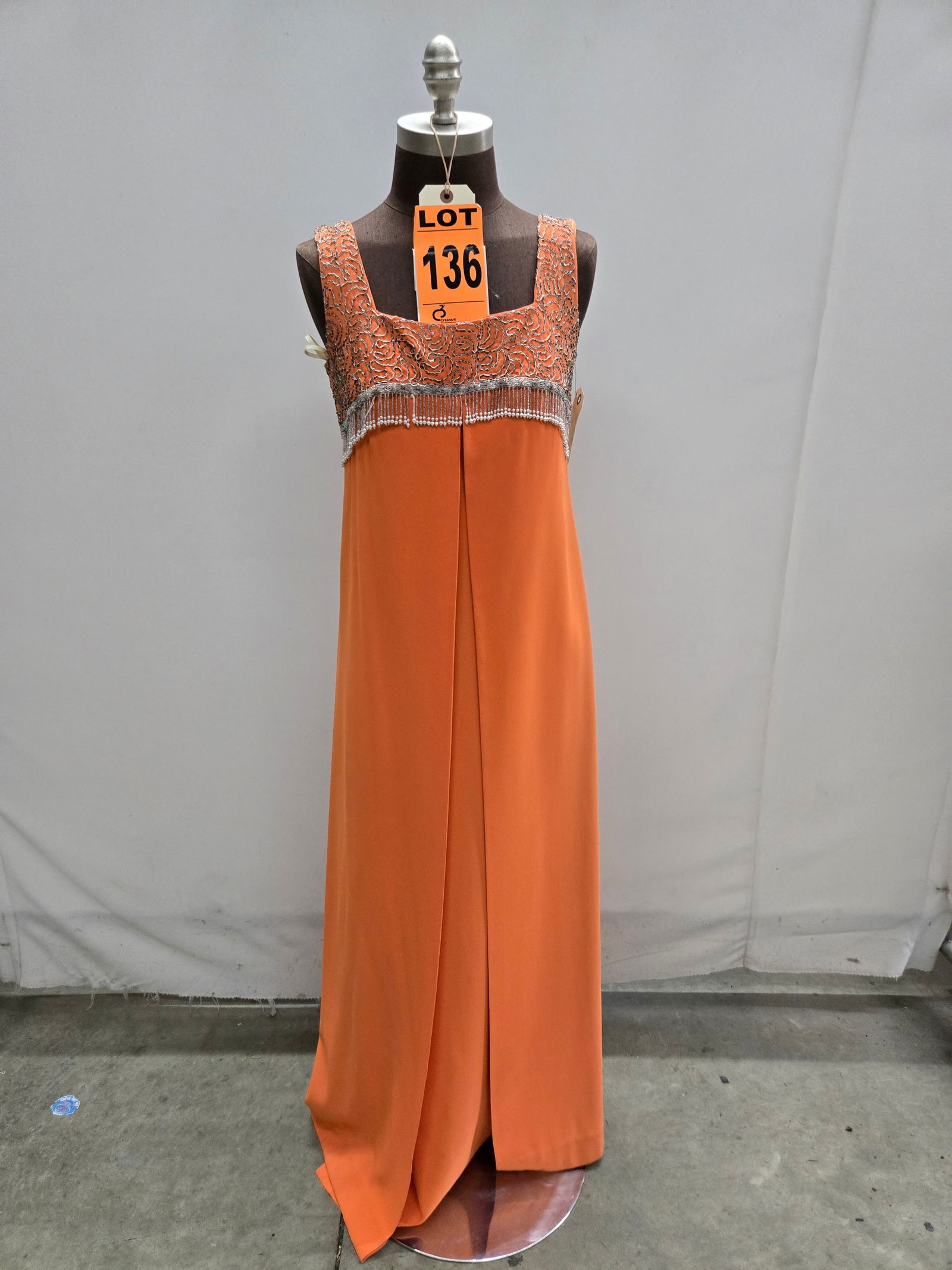 Evening gown, 1960s, orange poly crepe, silver seed-bead bodice with beaded fringe.: Evening gown, 1960s, orange poly crepe, silver seed-bead bodice with beaded fringe. IMPORTANT NOTE TO BIDDERS: We are not an auction gallery but a liquidator retained by CRC as they wind-down operatio