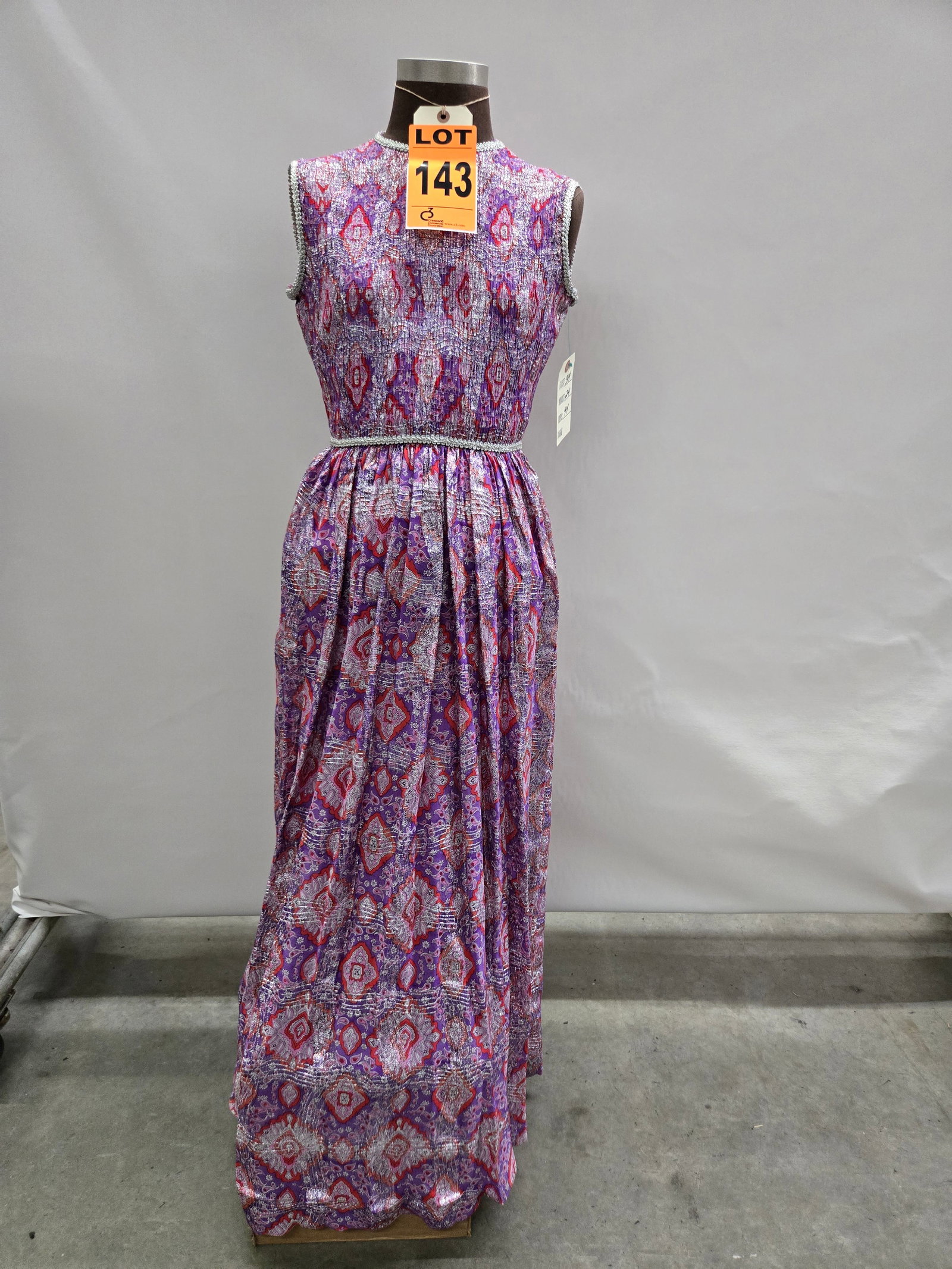 Evening gown, 1960s, purple/pink/red/white medallion-pattern silk with silver lamé wide plaid,: Evening gown, 1960s, purple/pink/red/white medallion-pattern silk with silver lamé wide plaid, by Drazen’s City of Fashion. IMPORTANT NOTE TO BIDDERS: We are not an auction gallery but a liquidator