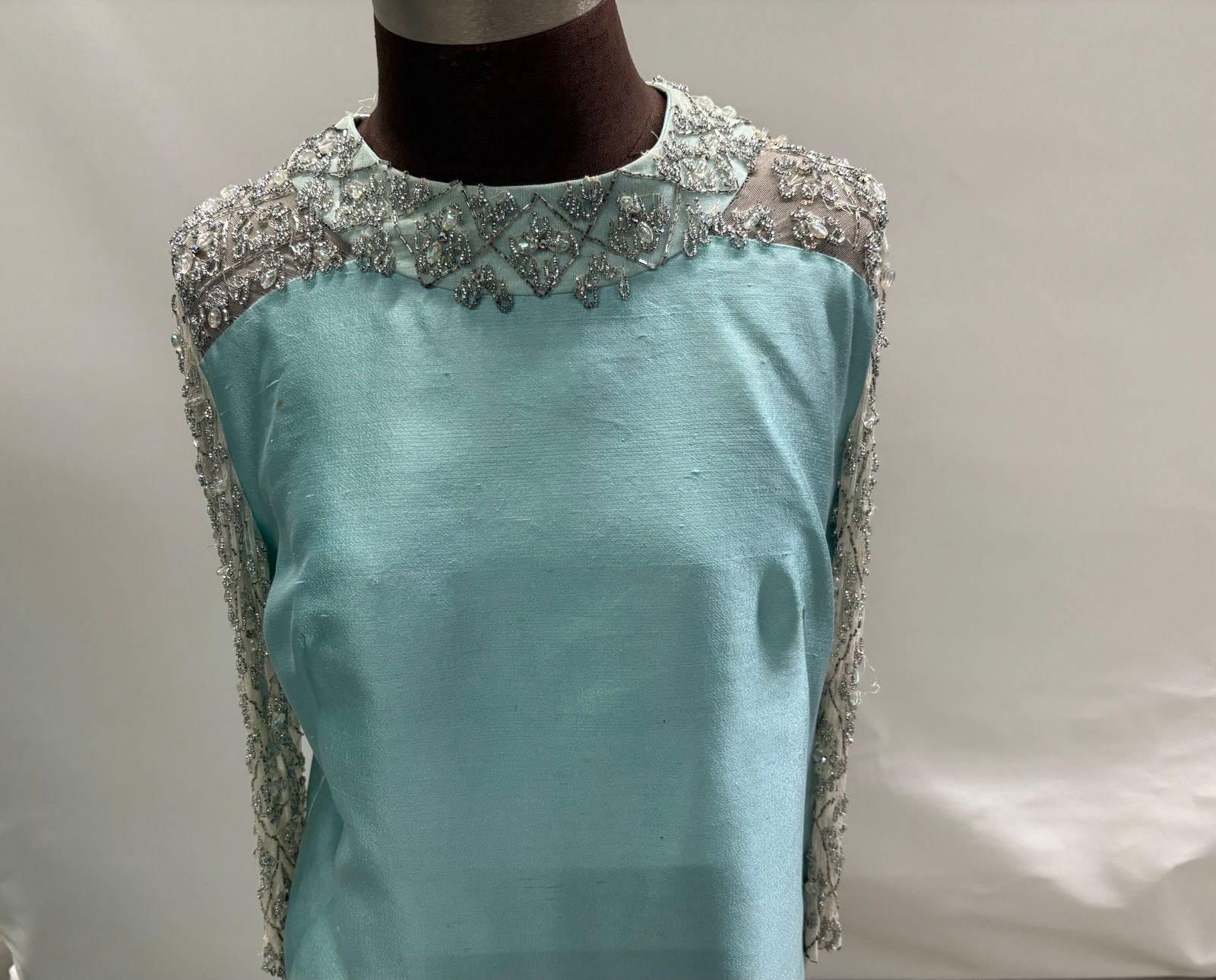 Evening gown, 1960s, baby-blue silk/wool, silver beads with AB crystals, rhinestone-beaded chiffon s: Evening gown, 1960s, baby-blue silk/wool, silver beads with AB crystals, rhinestone-beaded chiffon sleeves/neck. IMPORTANT NOTE TO BIDDERS: We are not an auction gallery but a liquidator retained by C