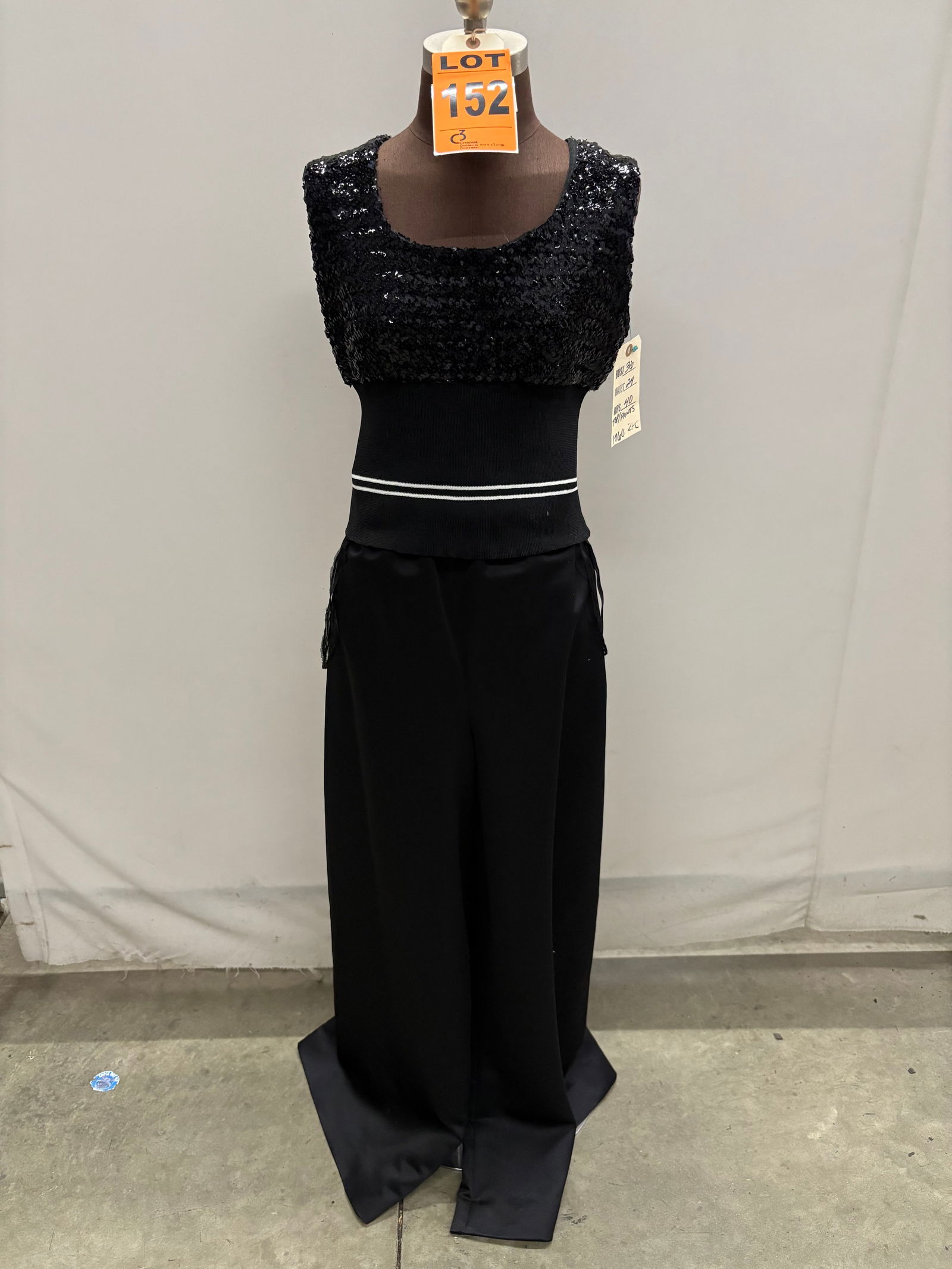 Pant suit, 1960s, black satin palazzo pants with black sequin/rib-knit shell (white stripes).: Pant suit, 1960s, black satin palazzo pants with black sequin/rib-knit shell (white stripes). IMPORTANT NOTE TO BIDDERS: We are not an auction gallery but a liquidator retained by CRC as they wind-dow