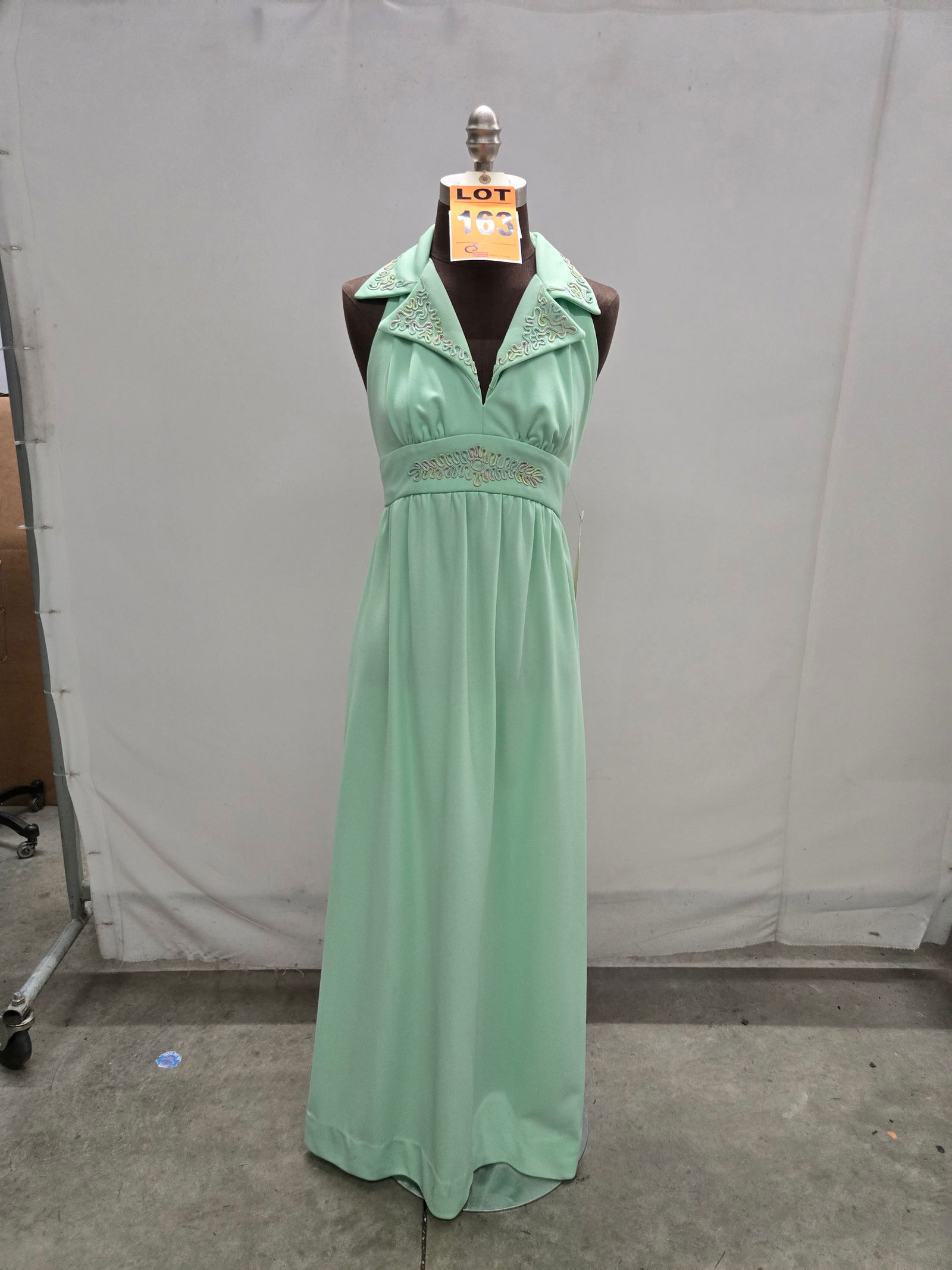 Evening gown, 1970s, mint-green polyester, multicolor pastel trapunto at waist/collar. (1 of 4)
