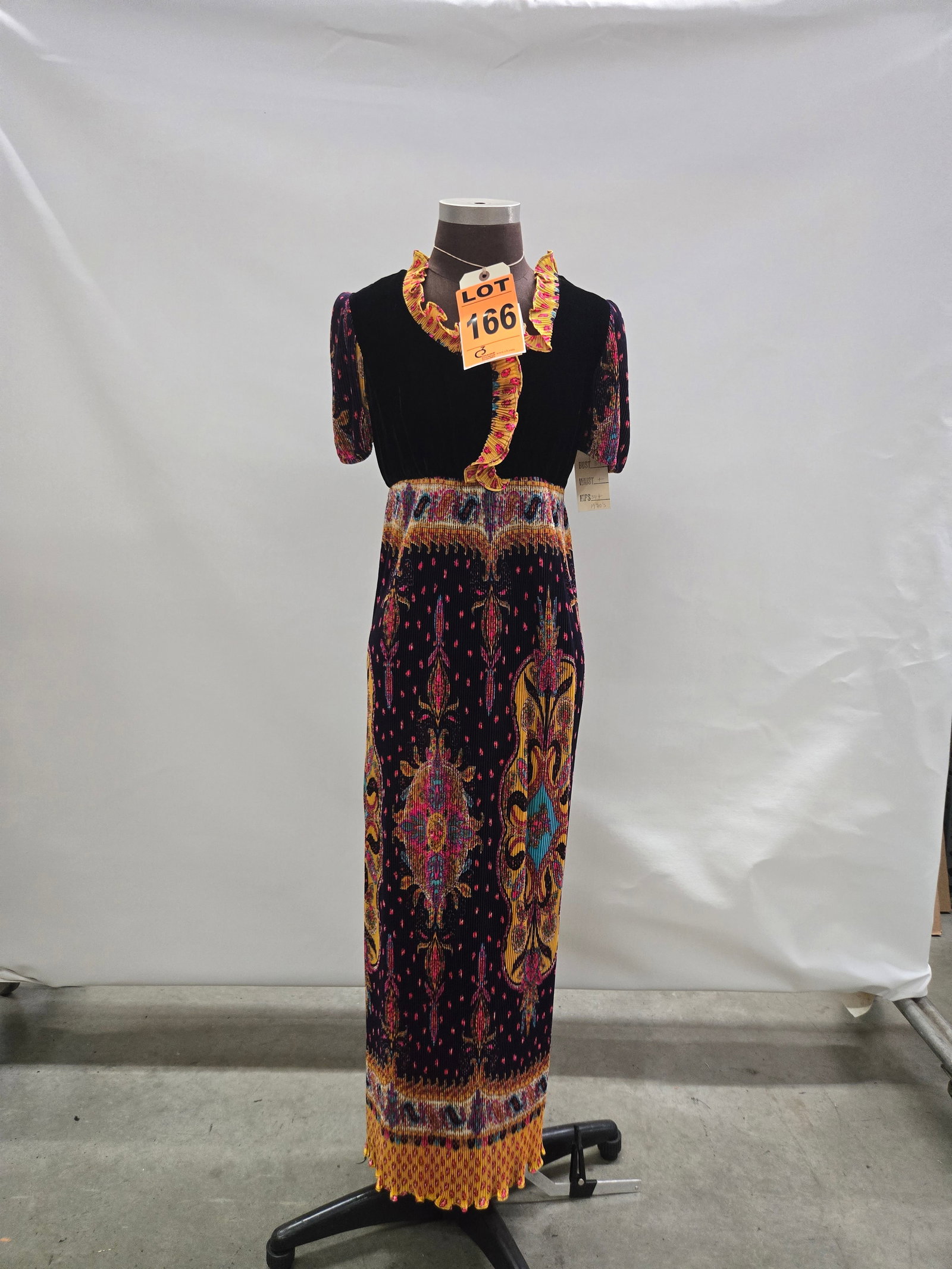 Evening gown, n/a, black velvet bodice with purple/pink/orange/green accordion-pleated medallion ski: Evening gown, n/a, black velvet bodice with purple/pink/orange/green accordion-pleated medallion skirt/sleeves, by One Flat F. IMPORTANT NOTE TO BIDDERS: We are not an auction gallery but a liquidator