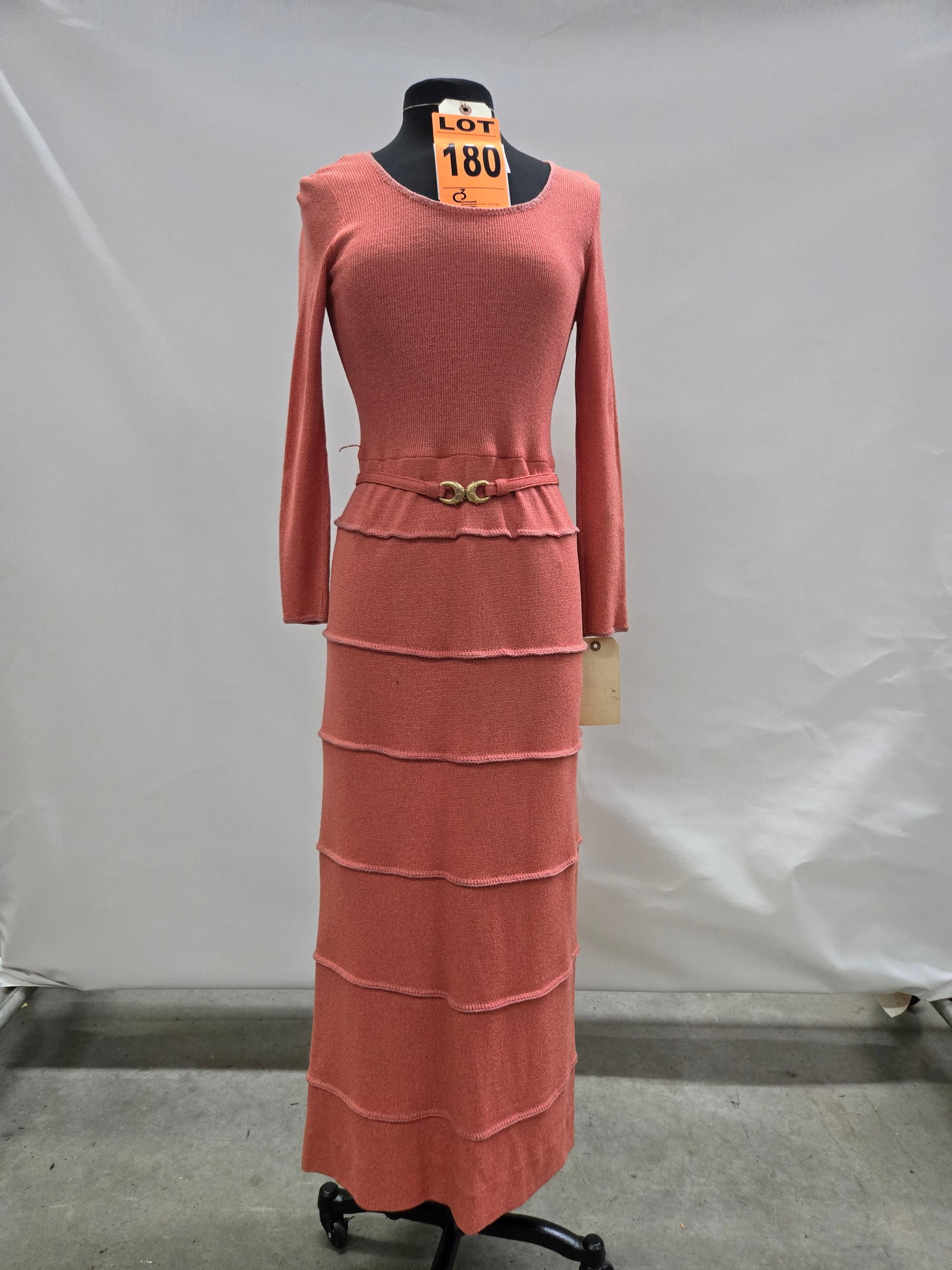 Evening dress set, 1970s, salmon-pink knit, seven-tier skirt with self belt, by Ayres Unlimited.: Evening dress set, 1970s, salmon-pink knit, seven-tier skirt with self belt, by Ayres Unlimited. IMPORTANT NOTE TO BIDDERS: We are not an auction gallery but a liquidator retained by CRC as they wind-