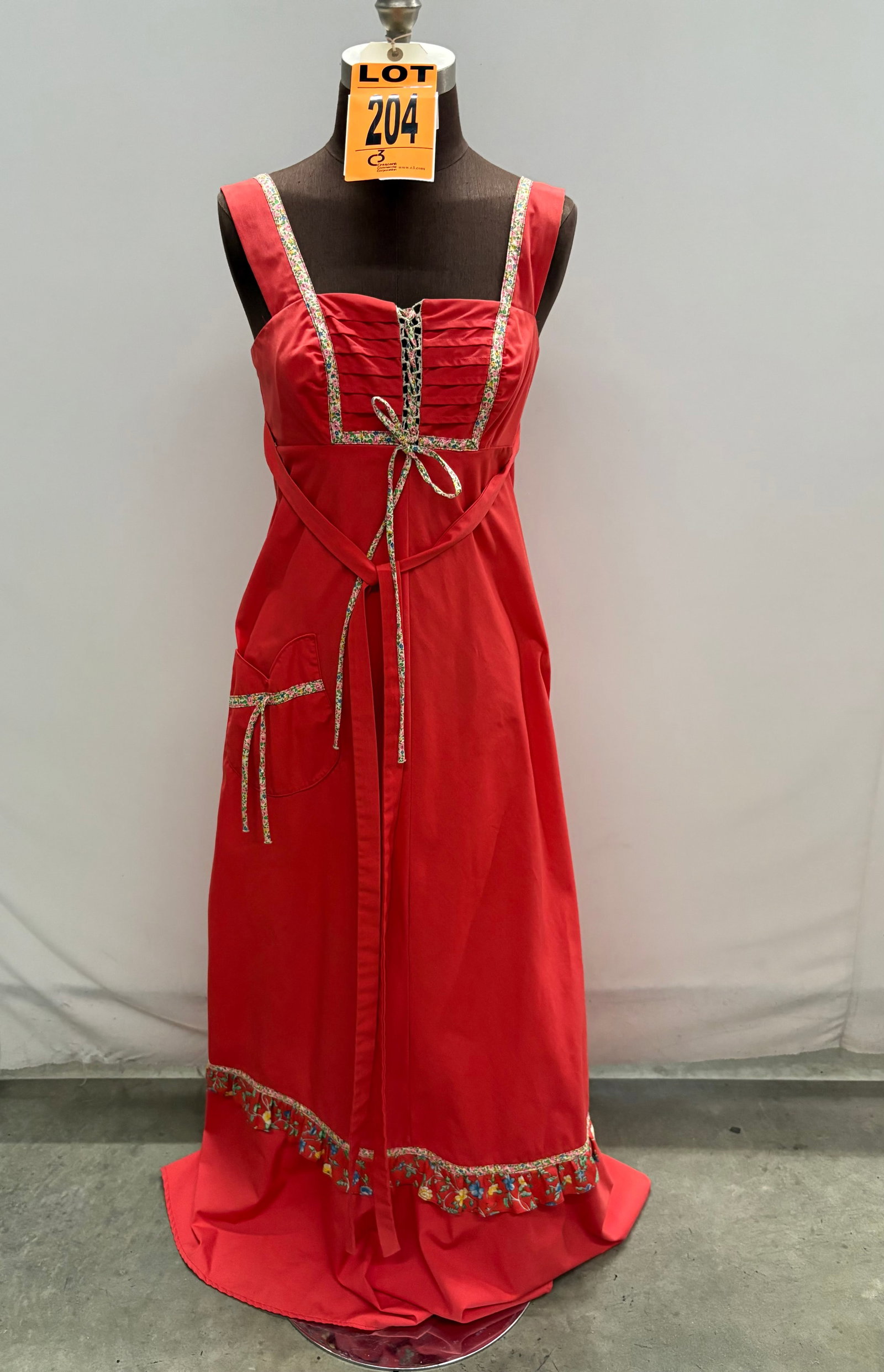 Evening gown, 1970s, salmon-pink cotton, calico trim in pink/yellow/blue with lace front and bow, ri: Evening gown, 1970s, salmon-pink cotton, calico trim in pink/yellow/blue with lace front and bow, ribbon straps, one pocket, self-tie belt, by Jody T. IMPORTANT NOTE TO BIDDERS: We are not an auction