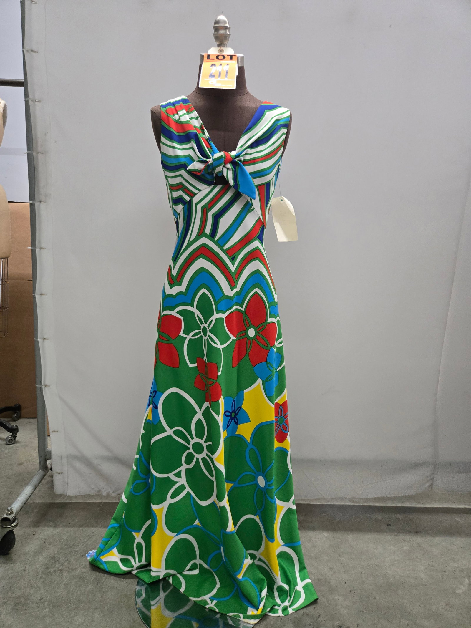 Evening gown, n/a, white/green/navy/orange/yellow floral-striped polyester, tie at bodice, by Tori R: Evening gown, n/a, white/green/navy/orange/yellow floral-striped polyester, tie at bodice, by Tori Richard. IMPORTANT NOTE TO BIDDERS: We are not an auction gallery but a liquidator retained by CRC as