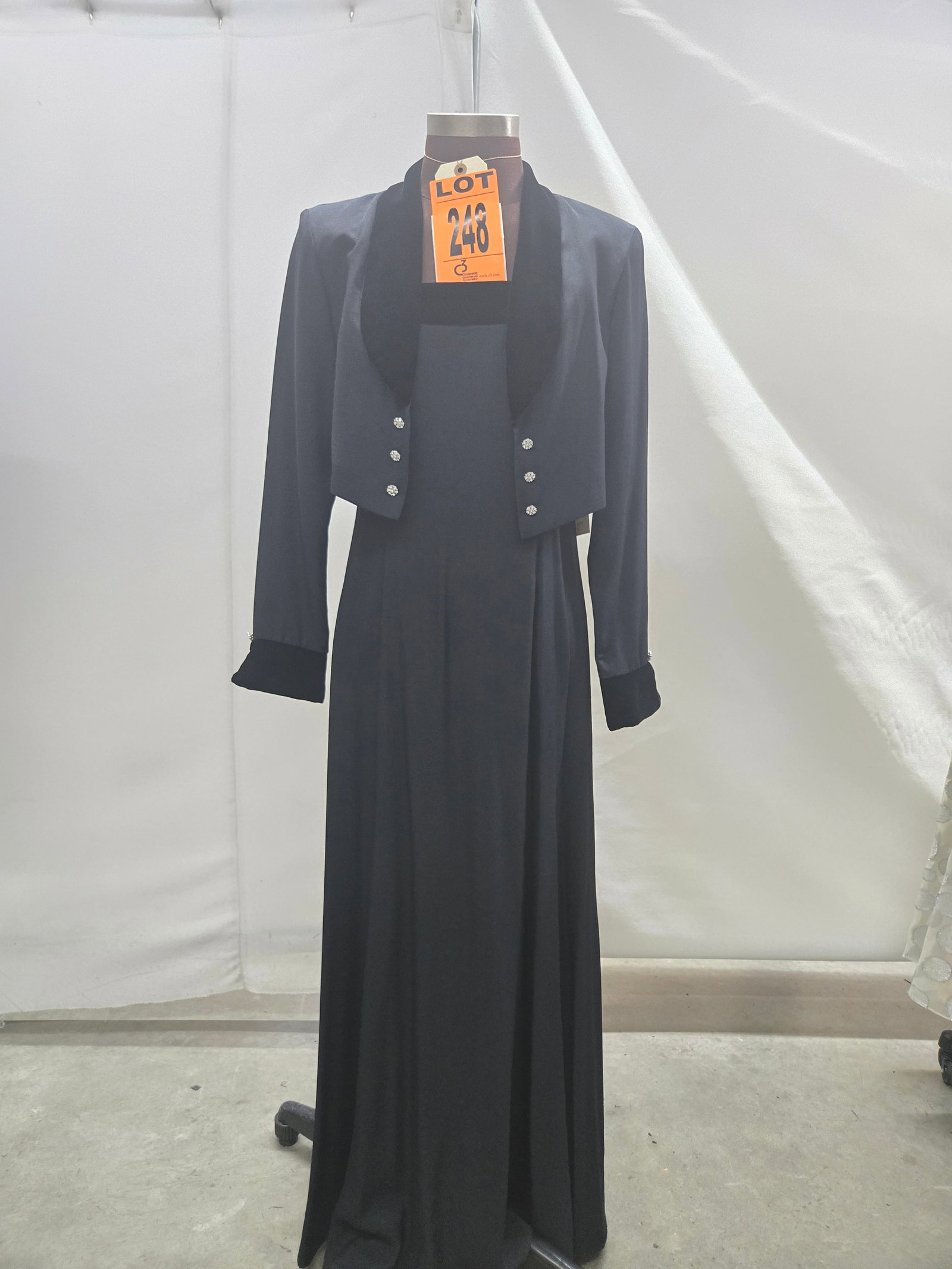 Evening gown set, 1980s, black crepe knit with spaghetti straps and black-velvet trim, bolero jacket: Evening gown set, 1980s, black crepe knit with spaghetti straps and black-velvet trim, bolero jacket, by J.R. Nights. IMPORTANT NOTE TO BIDDERS: We are not an auction gallery but a liquidator retained
