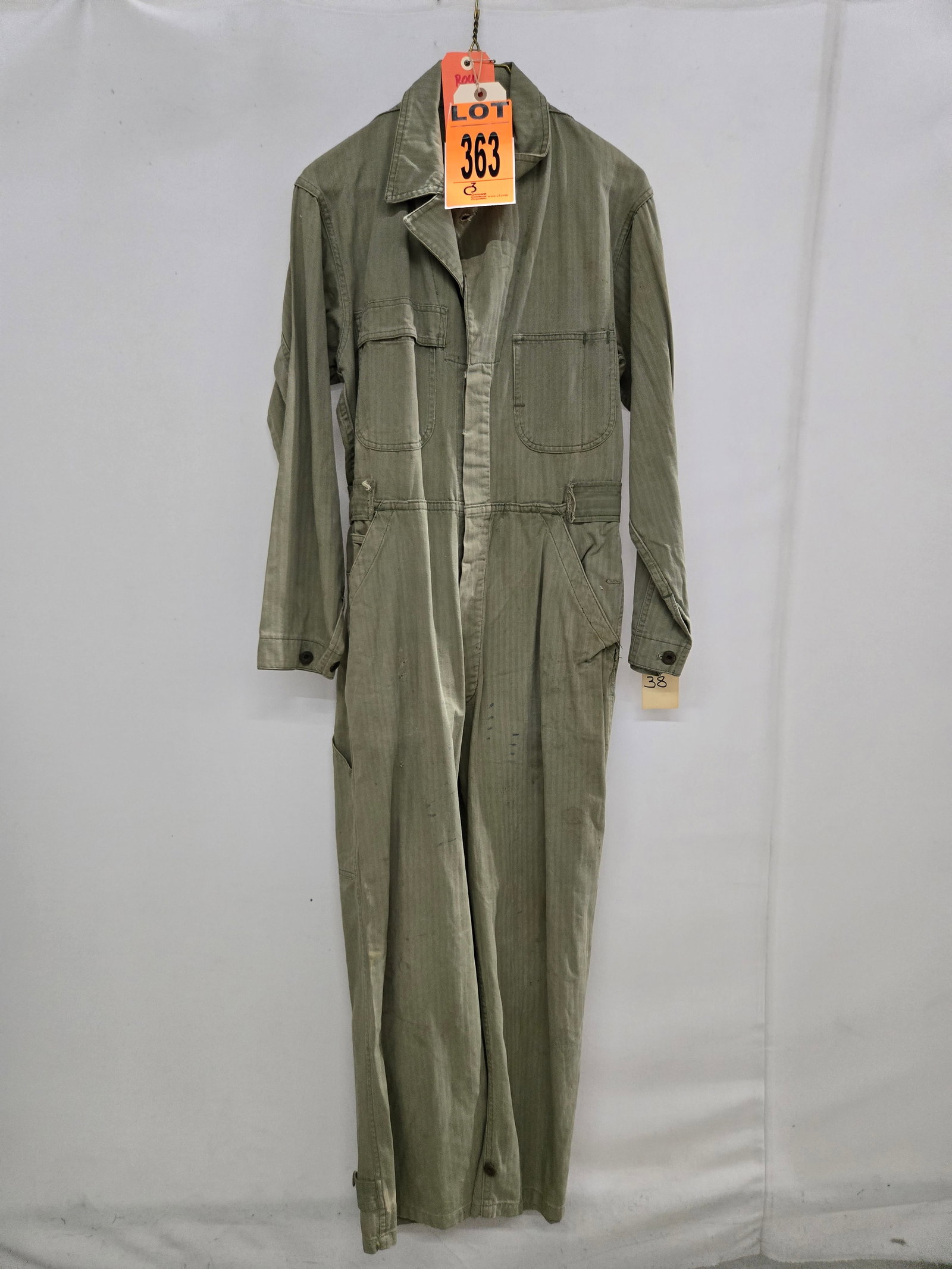 US Navy hbt one piece coveralls with navy wreath rivet buttons: US Navy hbt one piece coveralls with navy wreath rivet buttons in size 38. Features early biswing back and twin breast pockets with modified right breast pocket flap added. Waist belt cut and removed 