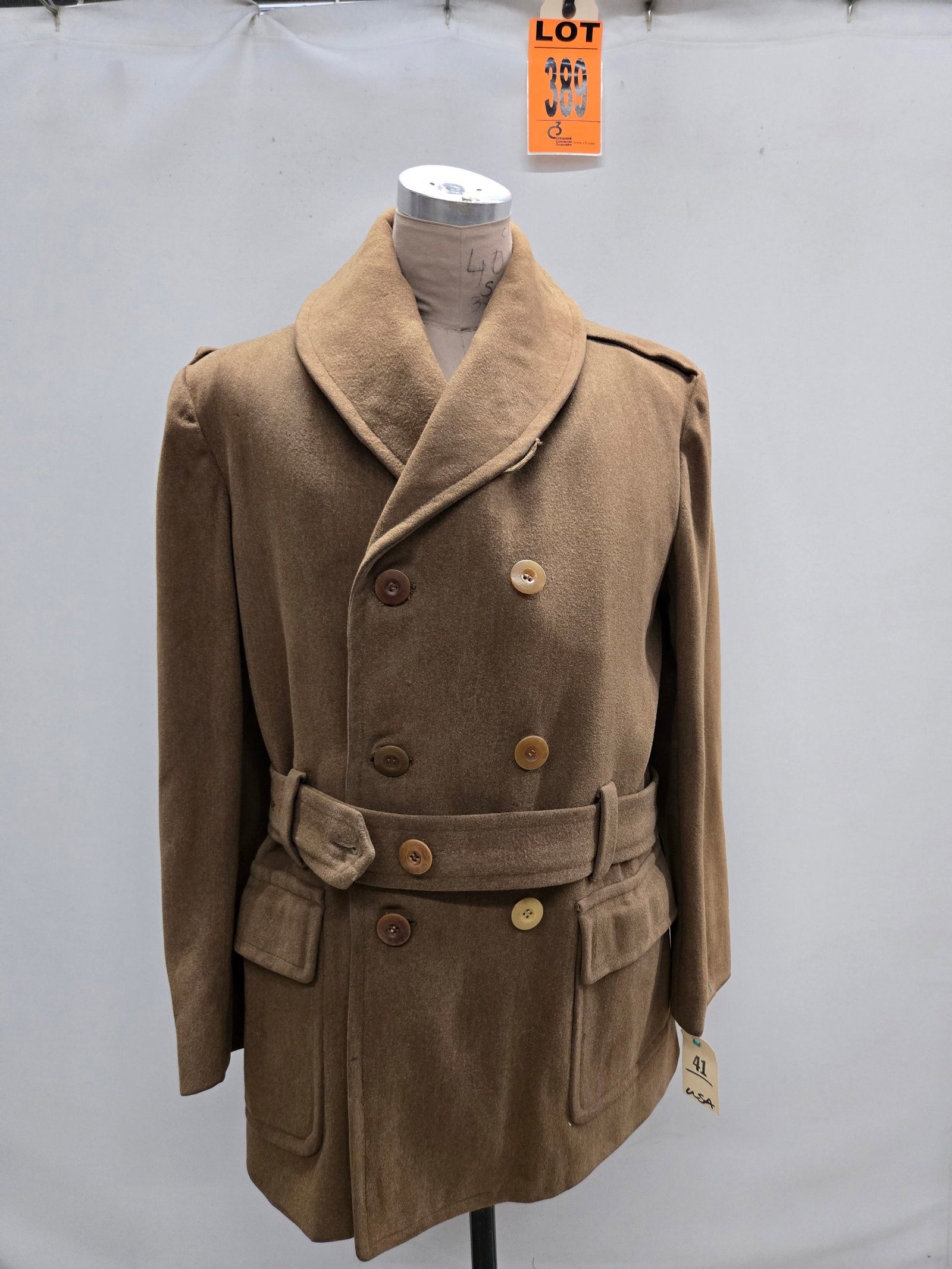 O?cers quality tailor made coat in size 41, complete with waist belt: O?cers quality tailor made coat in size41. Complete with waist belt. (1 pcs). dated WWII Location: Row 31A, Item #13 IMPORTANT NOTE TO BIDDERS: We are not an auction gallery but a liquidator retained 