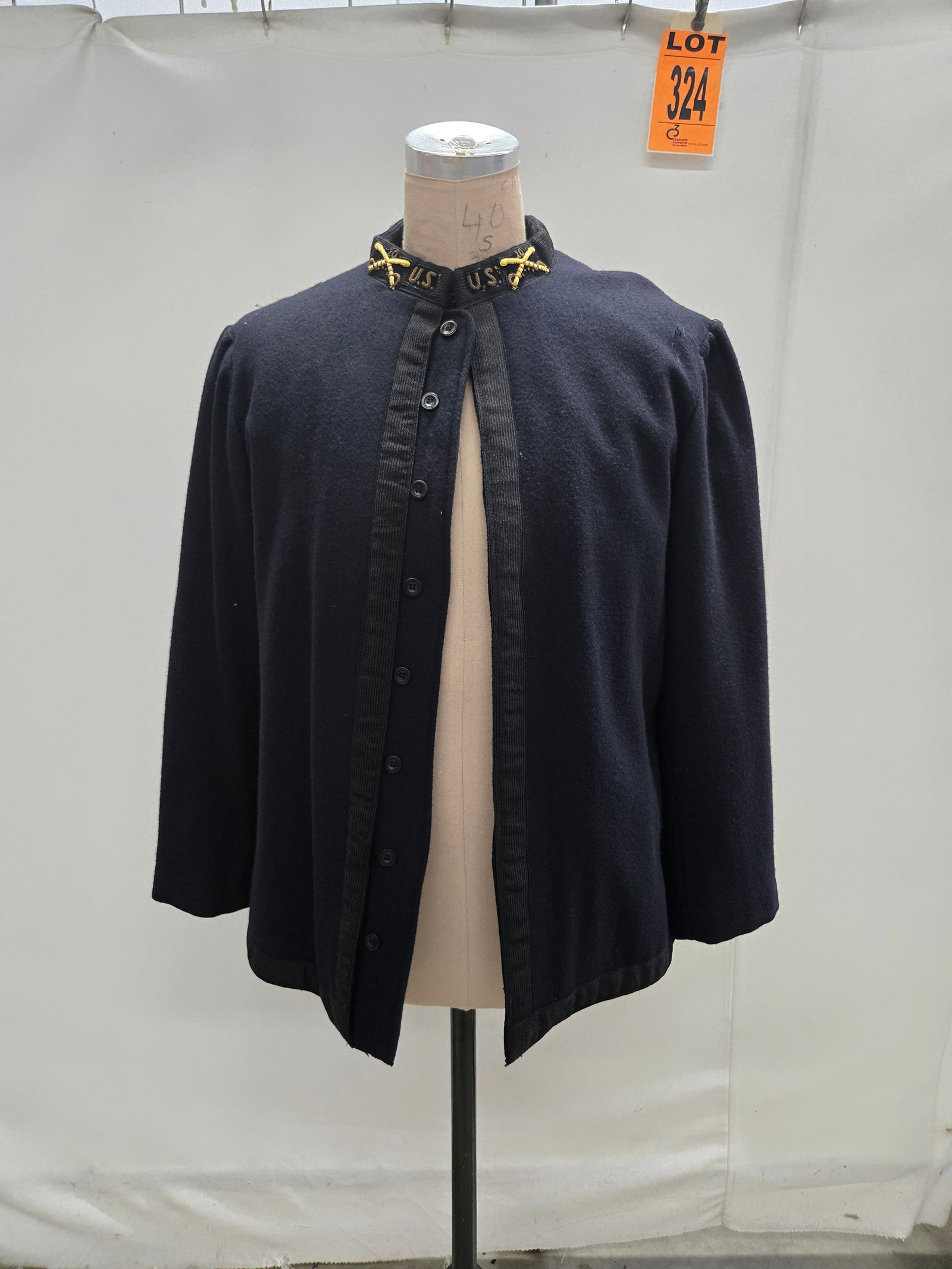 10th Cavalry O?cer’s dress tunic, black, studio made w/ bullion insignias. (1 pcs). featured in: 10th Cavalry O?cer’s dress tunic, black, studio made w/ bullion insignias. (1 pcs). featured in TNT’s BUFFALO SOLDIERS (1997) Location: Row 26A, Item #25 IMPORTANT NOTE TO BIDDERS: We are not an a