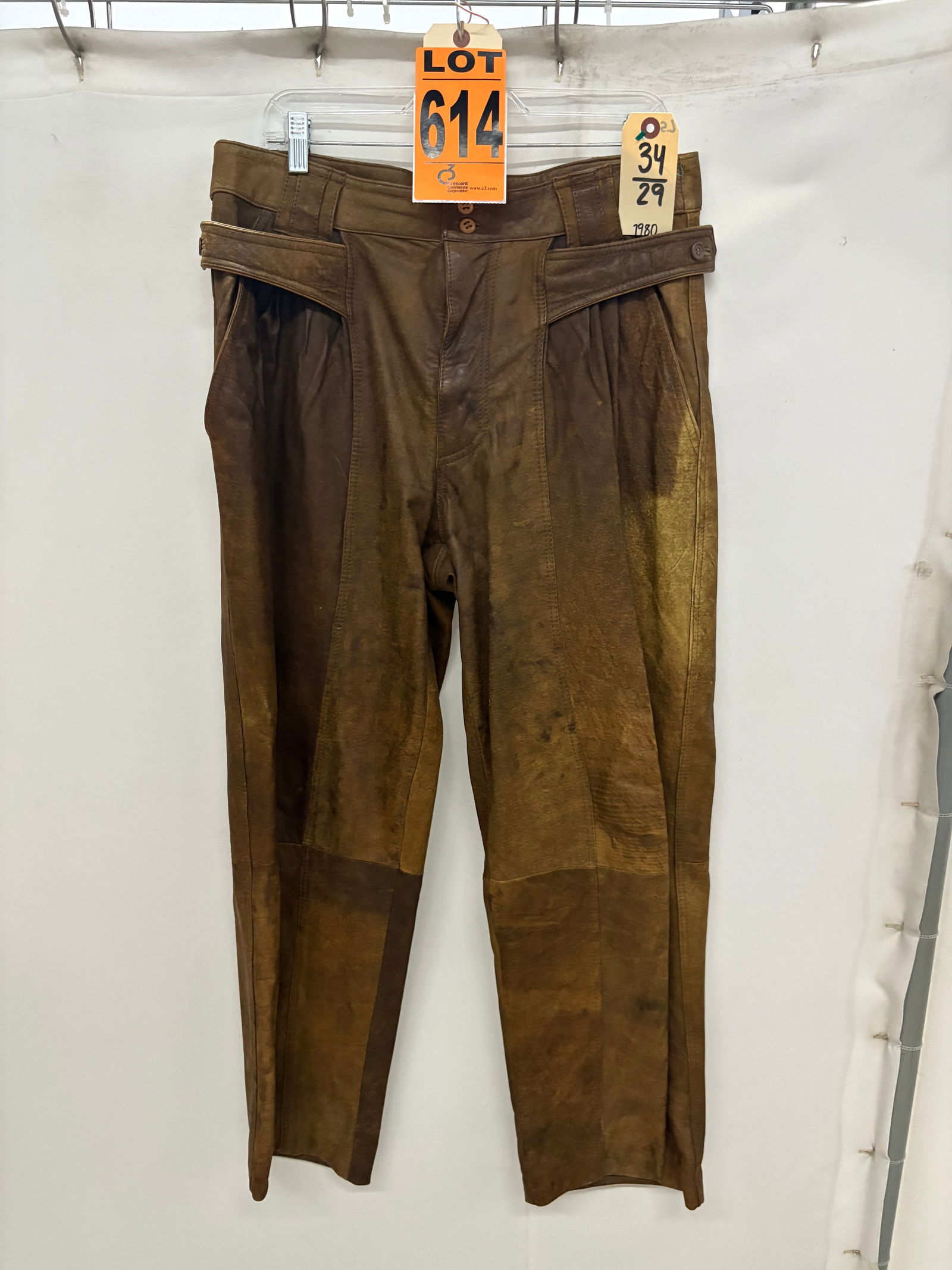 Pants, 1980s brown leather, purposefully distressed, high waist, half belt loops: Pants, 1980s brown leather, purposefully distressed, high waist, half belt loops IMPORTANT NOTE TO BIDDERS: We are not an auction gallery but a liquidator retained by CRC as they wind-down operations.