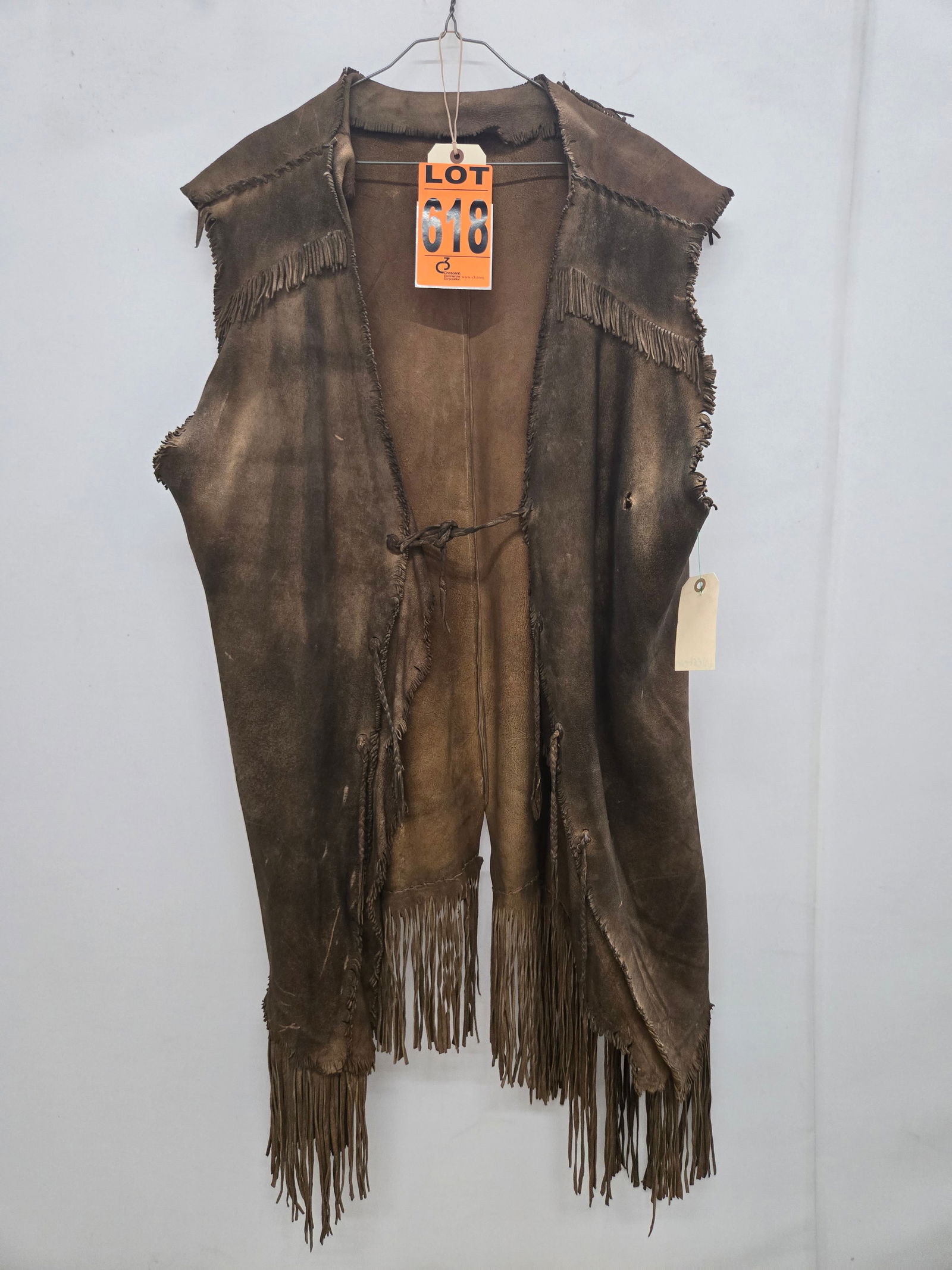 Frontier vest, brown distressed leather with fringe: Frontier vest, brown distressed leather with fringe IMPORTANT NOTE TO BIDDERS: We are not an auction gallery but a liquidator retained by CRC as they wind-down operations. As such, we cannot offer the