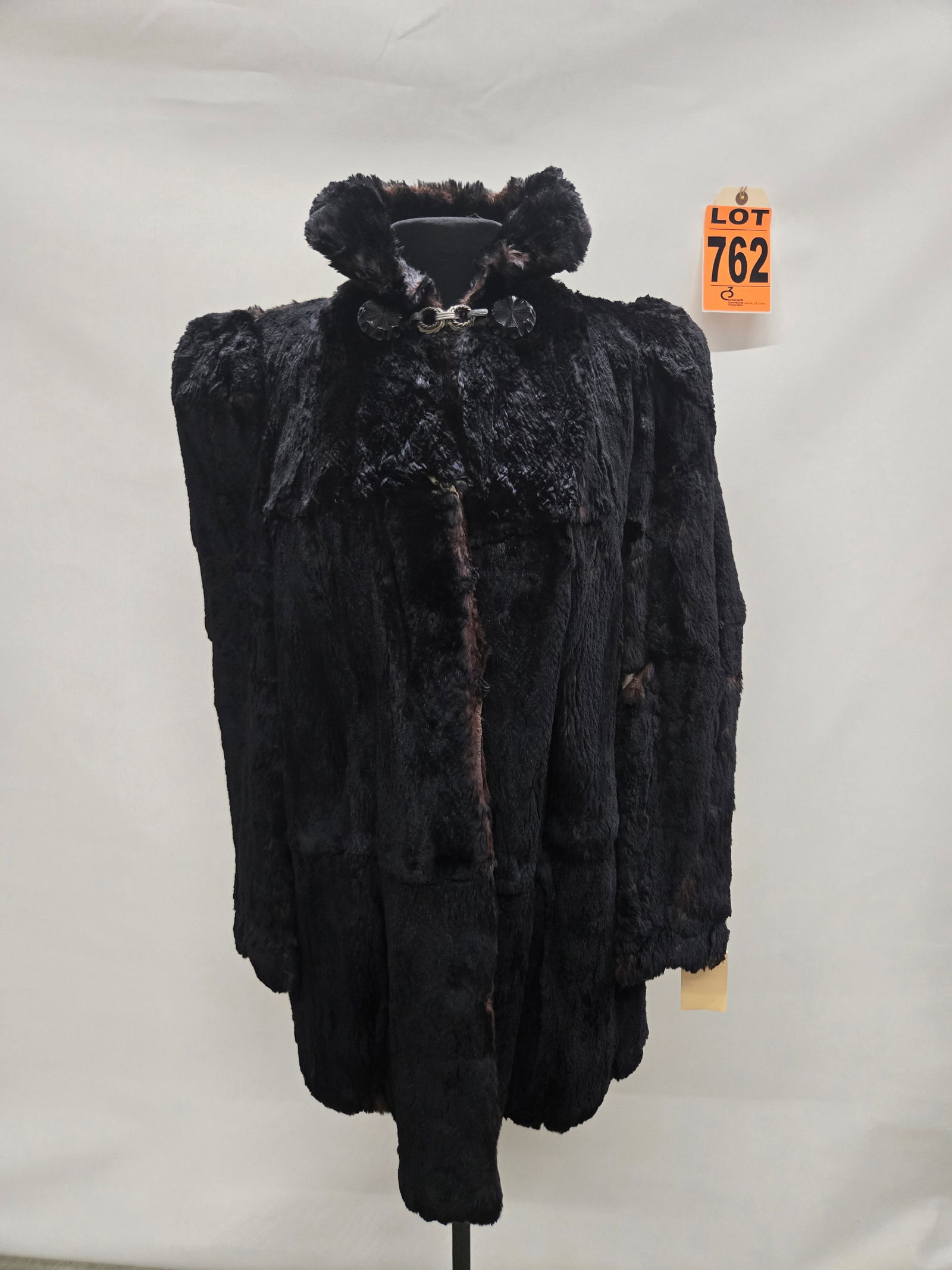 1930s black seal or beaver fur coat with art deco clasp at neck, some damage: 1930s black seal or beaver fur coat with art deco clasp at neck, some damage IMPORTANT NOTE TO BIDDERS: We are not an auction gallery but a liquidator retained by CRC as they wind-down operations. As