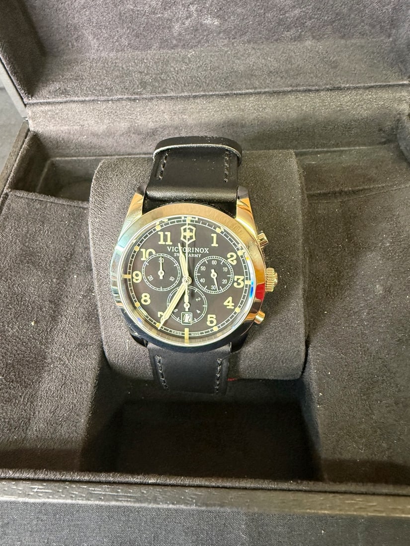 Victorinox Infantry Chronograph: 40mm case with black dial with crÃ¨me hands and numbers/markers, three subdials, Quartz chronograph,10 ATM, Silver polished bezel and black leather band with silver clasp. Dial is 1 5/8â