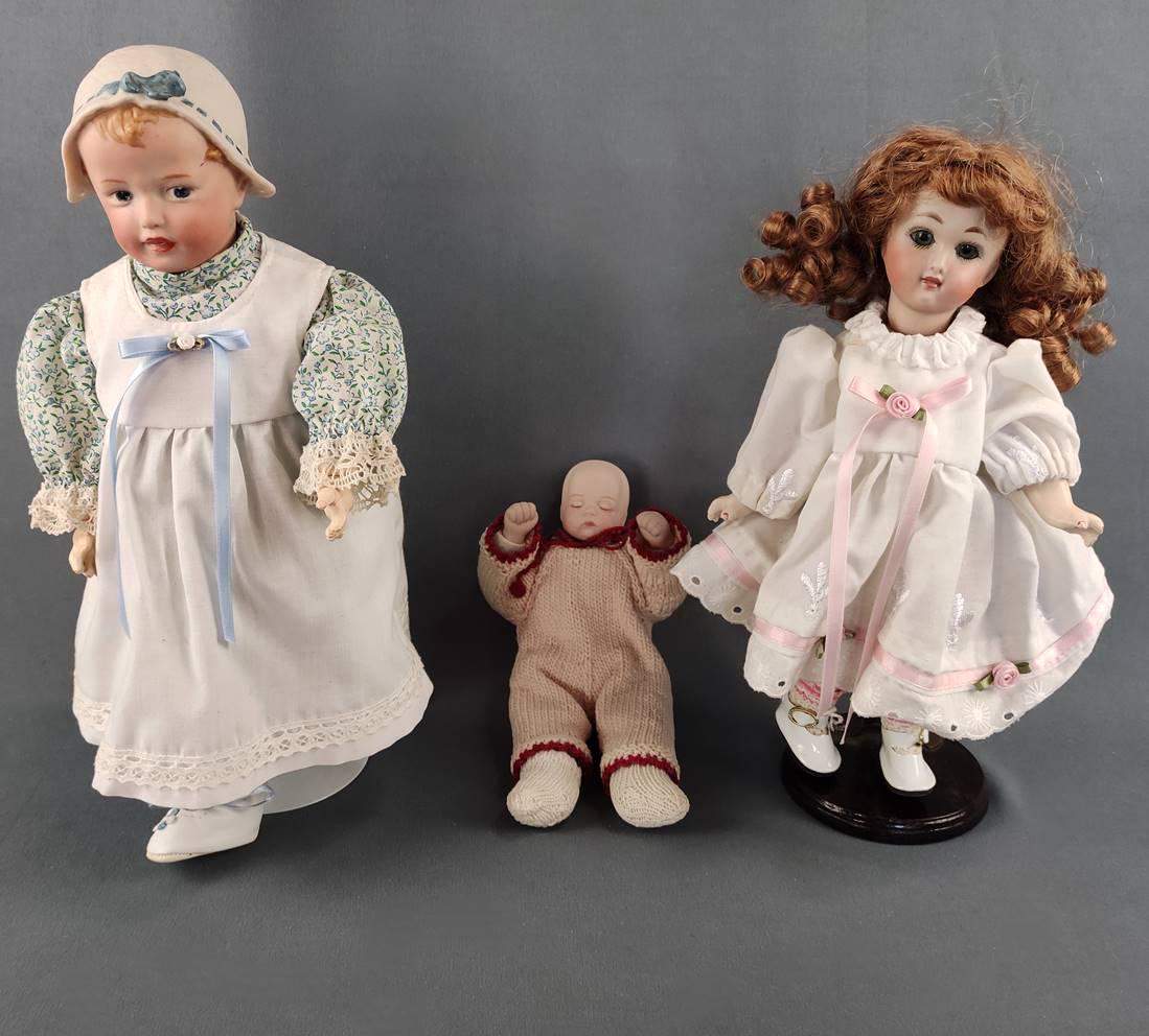 Three dolls, one in flowered dress and white shoes, bisque porcelain head, (1 of 9)