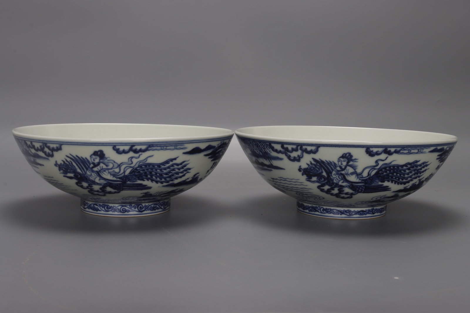 Ming Dynasty Xuande blue and white flute-blowing and phoenix-attracting bowl: A pair of Ming Dynasty Xuande blue and white flute-shaped bowls, 8 cm high, 21.5 cm in diameter, and 9 cm in base. Provenance:Private collection, Connecticut. Our dedicated team expertly handles both 