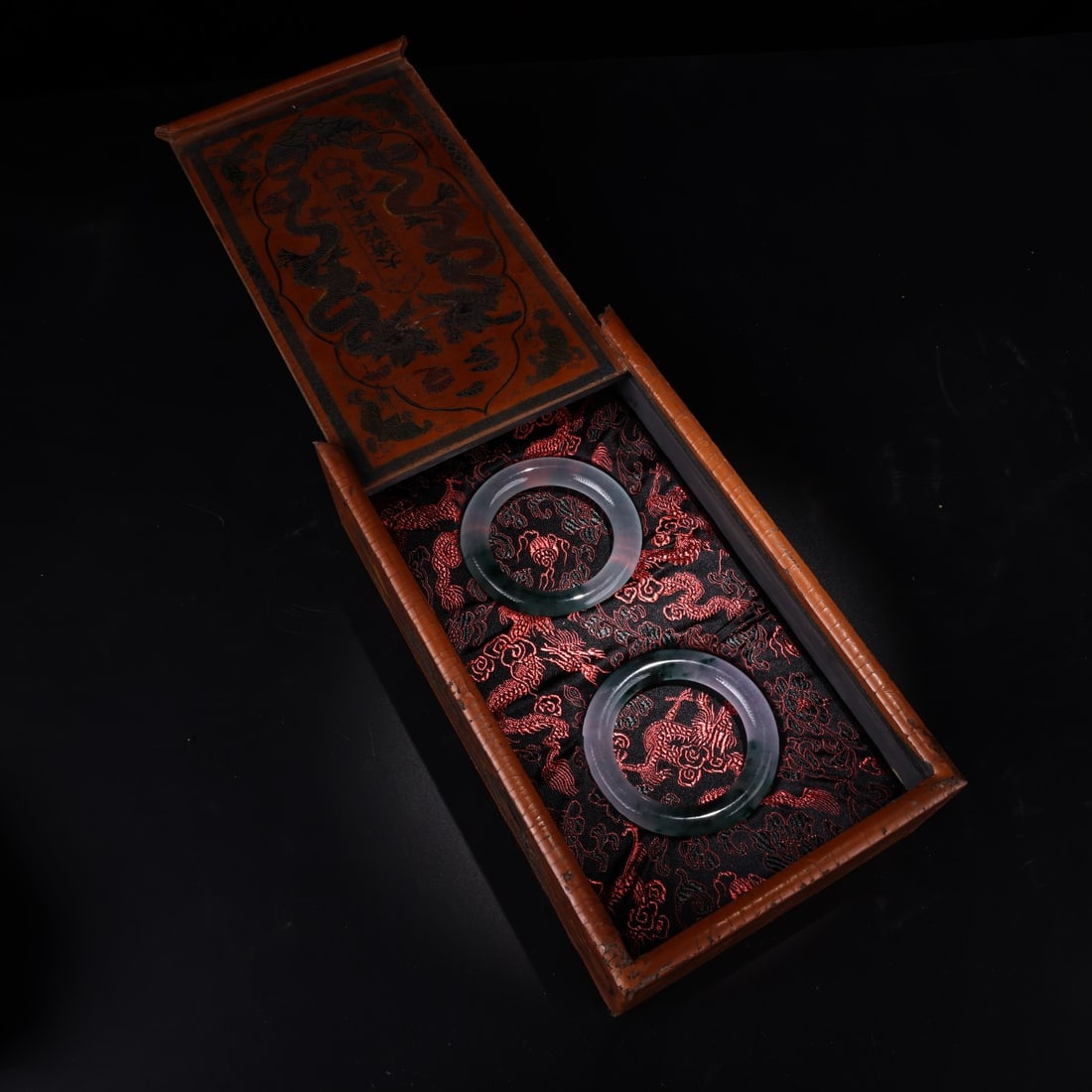 A pair of rare and exquisite Qing Dynasty imperial jadeite bracelets, paired with an antique lacquer (1 of 9)