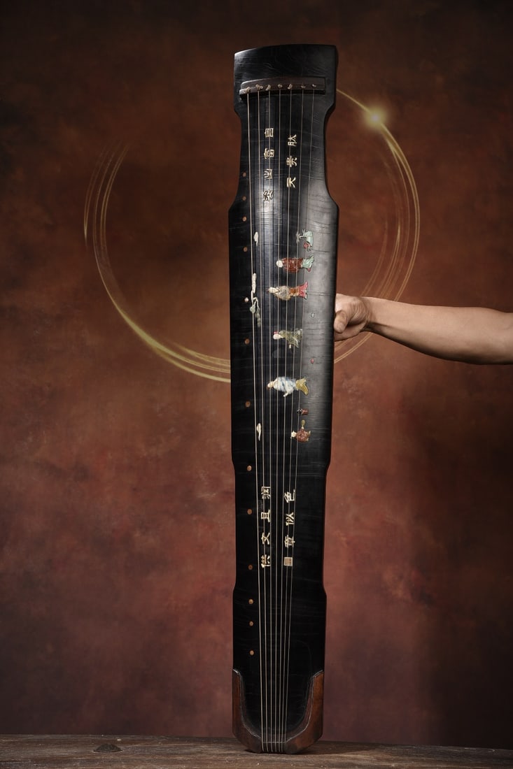 A seven-stringed guqin with a wooden base, lacquer finish, inlaid with jade and shell carvings. (1 of 9)