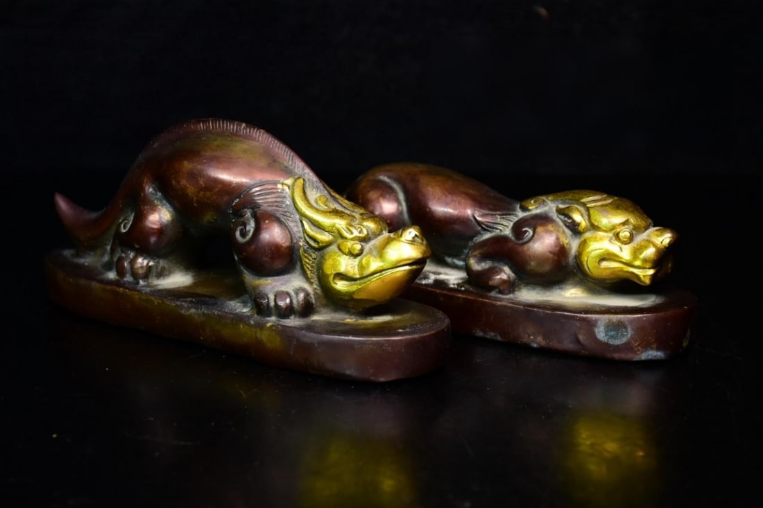 Mid-Qing Dynasty Gilded Bronze Paperweight: A pair of mid-Qing Dynasty gilt bronze paperweights, finely carved, with a rich patina and in perfect condition, 65 x 145 cm, 415 grams. Provenance:Private collection, Middletown, Rhode Island. Our de