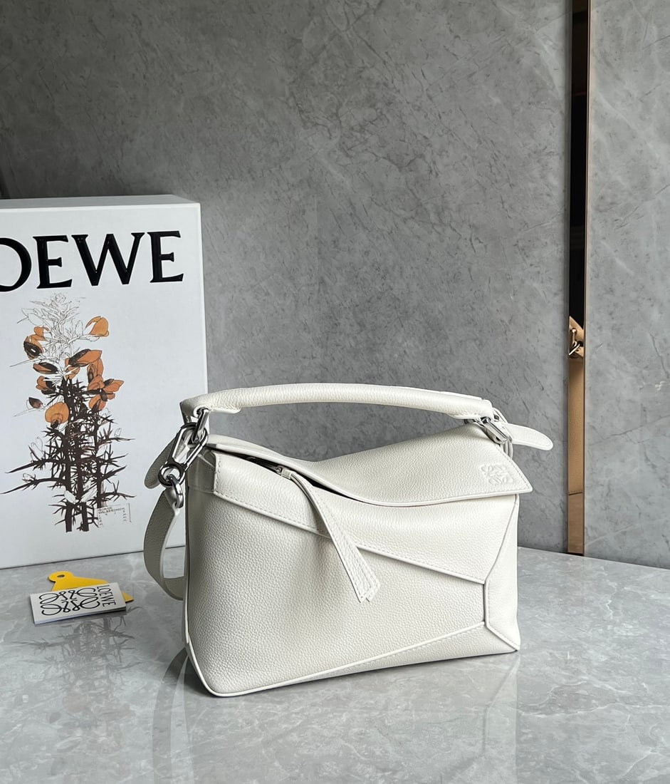 LOEWE: The LOEWE Puzzle bag, a celebrity favorite, is made of pebbled cowhide leather. The entire bag is constructed from pebbled leather panels, making it lightweight yet surprisingly spacious. Practical, v